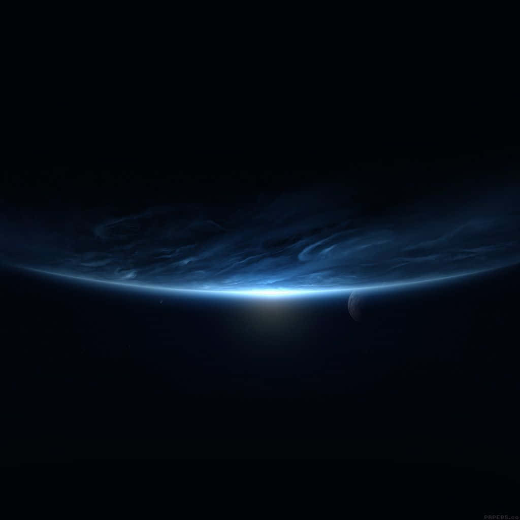 Download Black iPad With Blue Planet In Outer Space Wallpaper