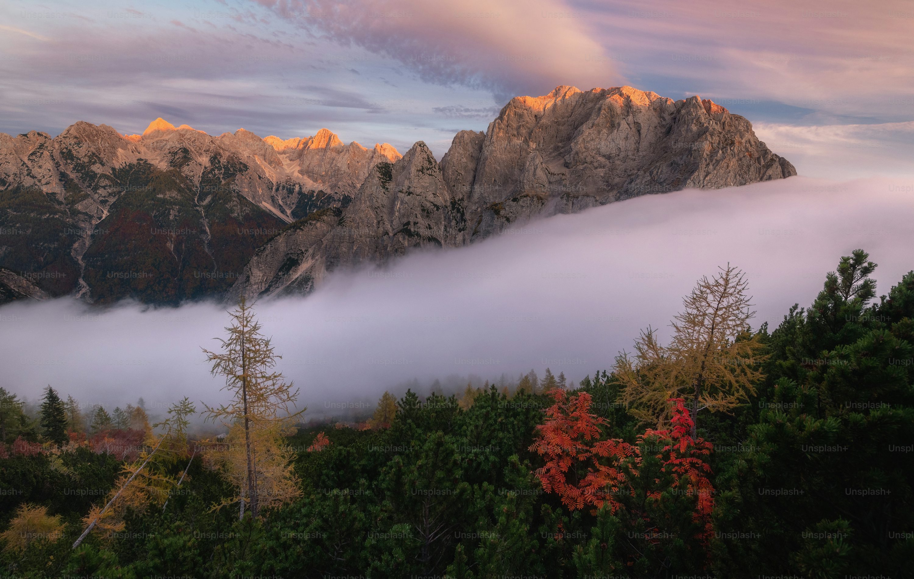 A view of a mountain covered in low lying clouds photo