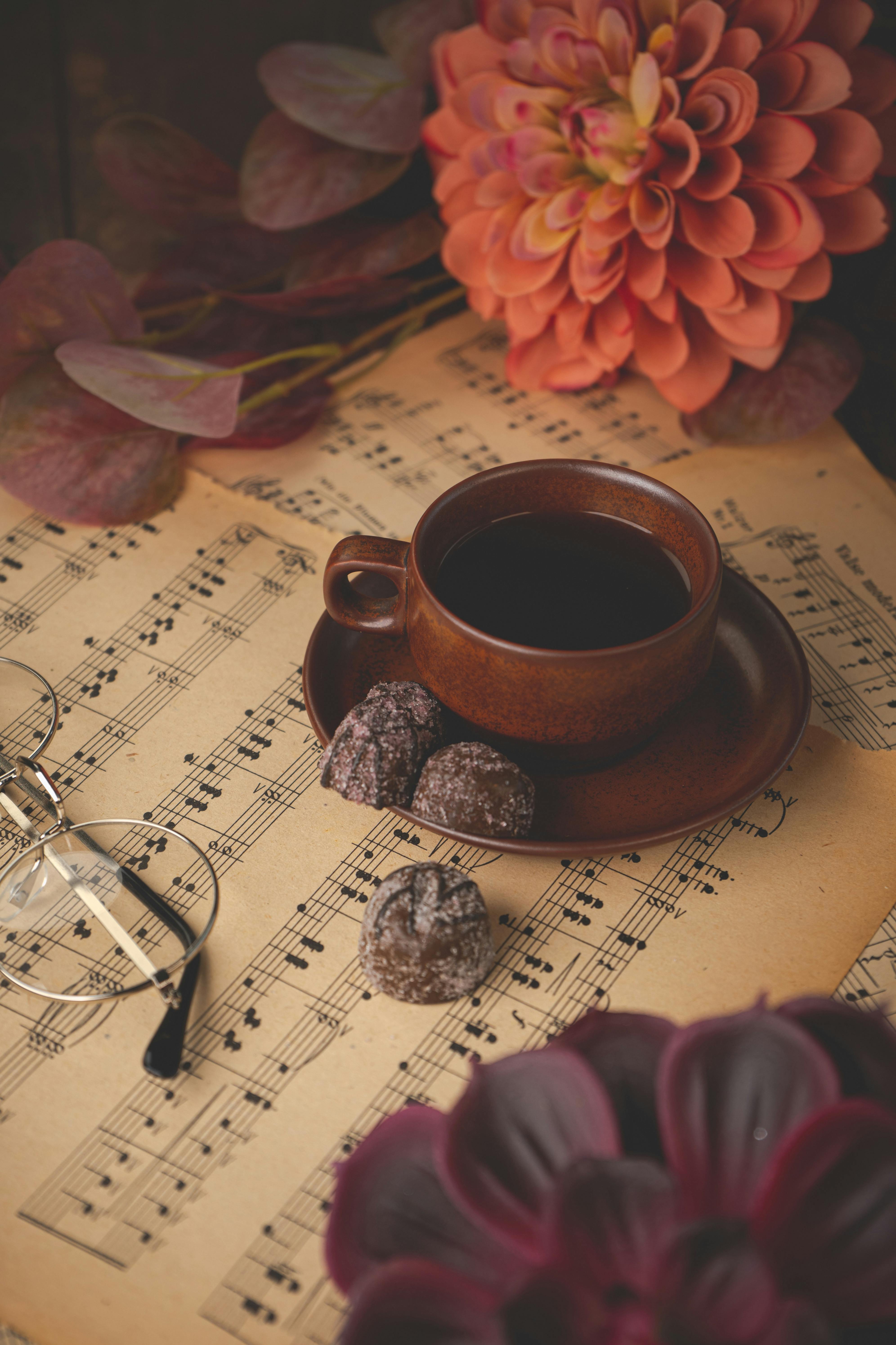 Cozy Autumn Coffee with Chocolates on Sheet Music · Free
