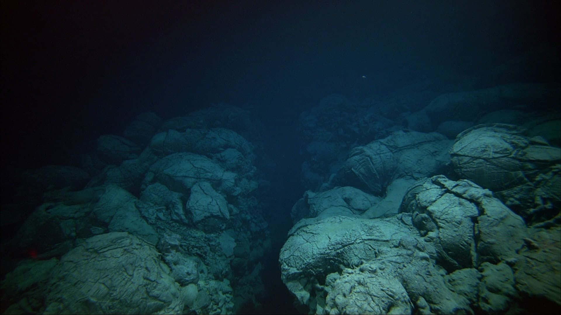 Download A View Of A Large Rock Formation In The Ocean