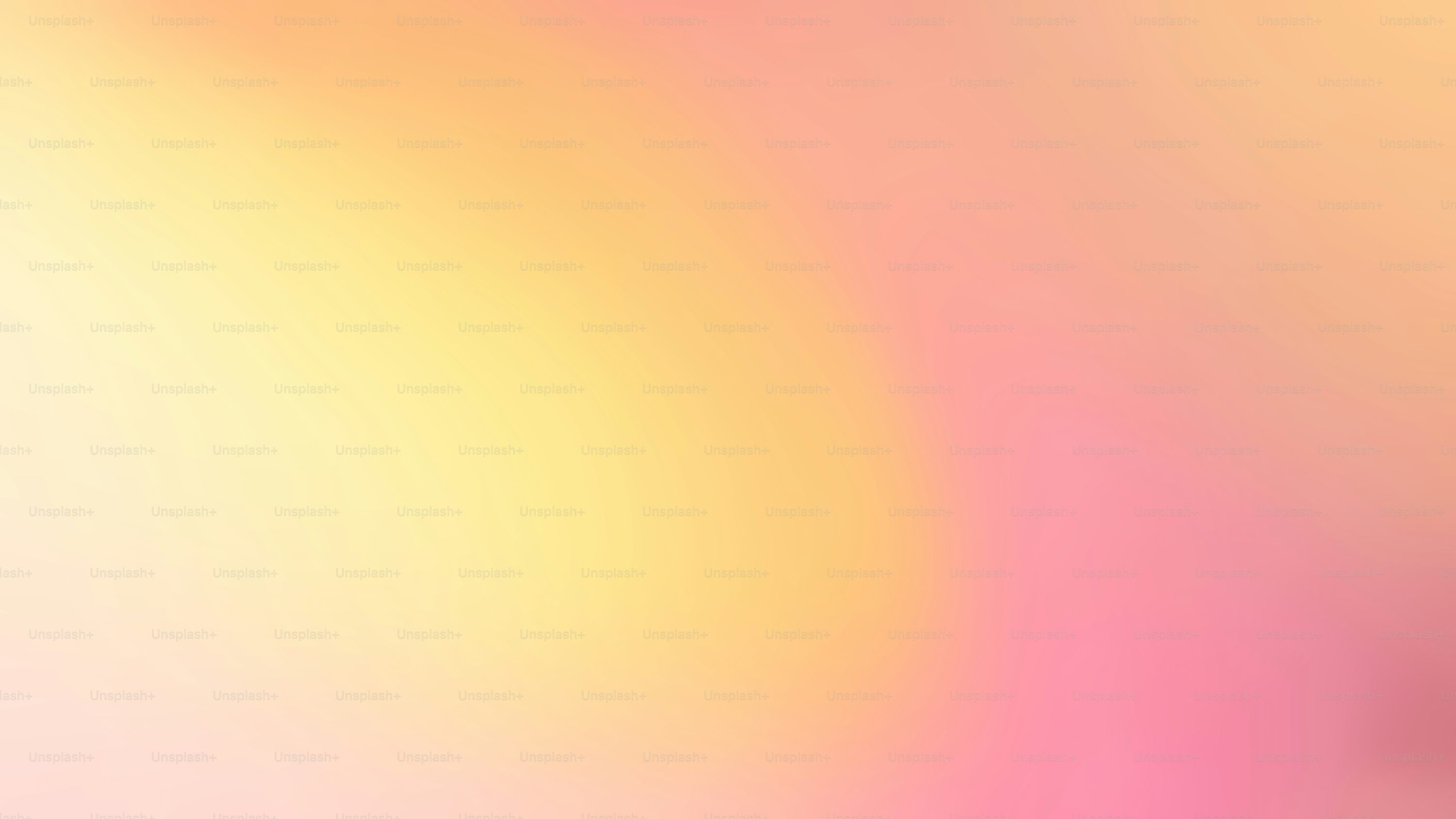 A blurry image of a pink and yellow background photo