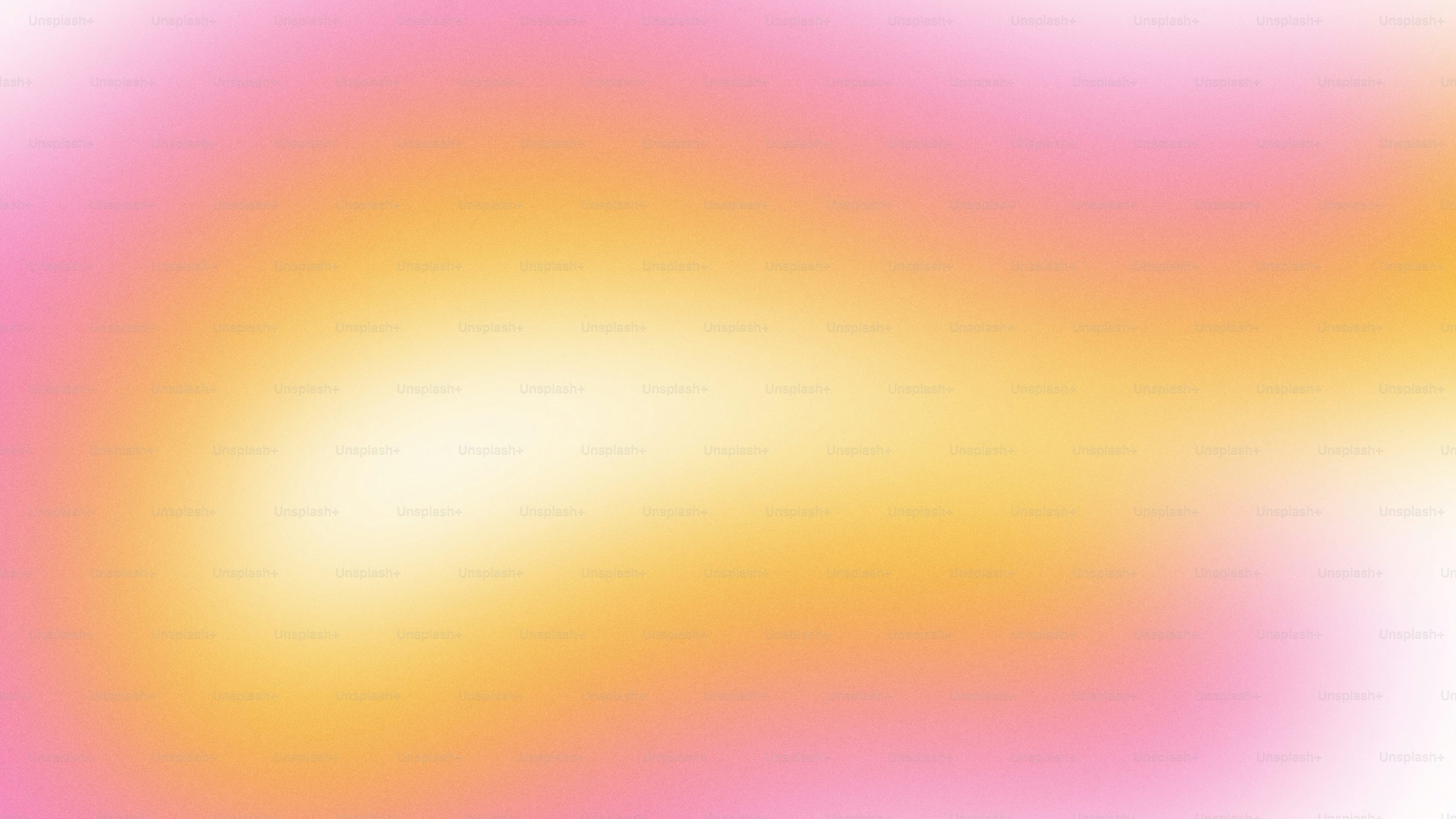 A blurry image of a pink and yellow background photo