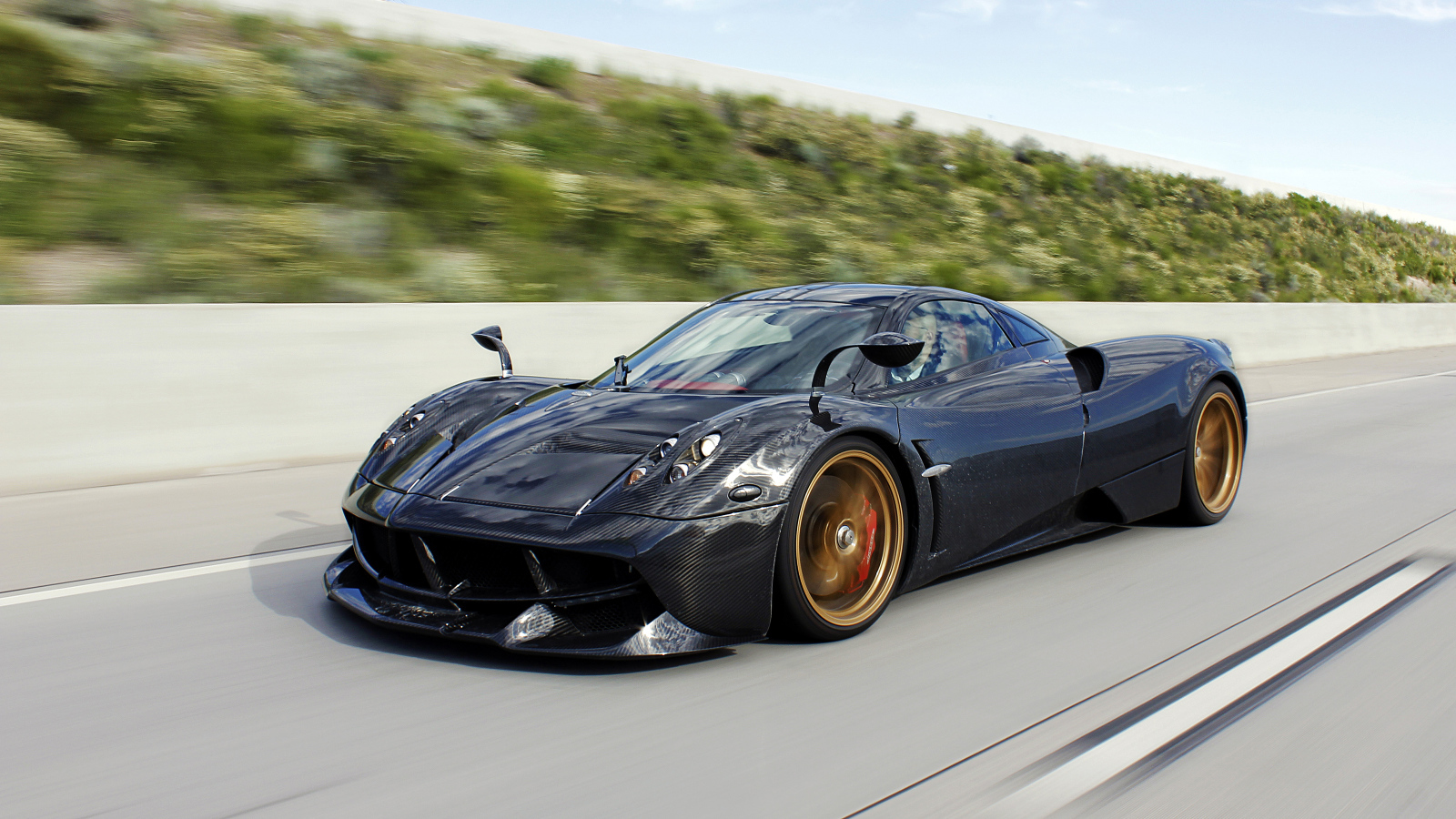 Black sports car Pagani Huayra on the road Desktop wallpaper 1600x900