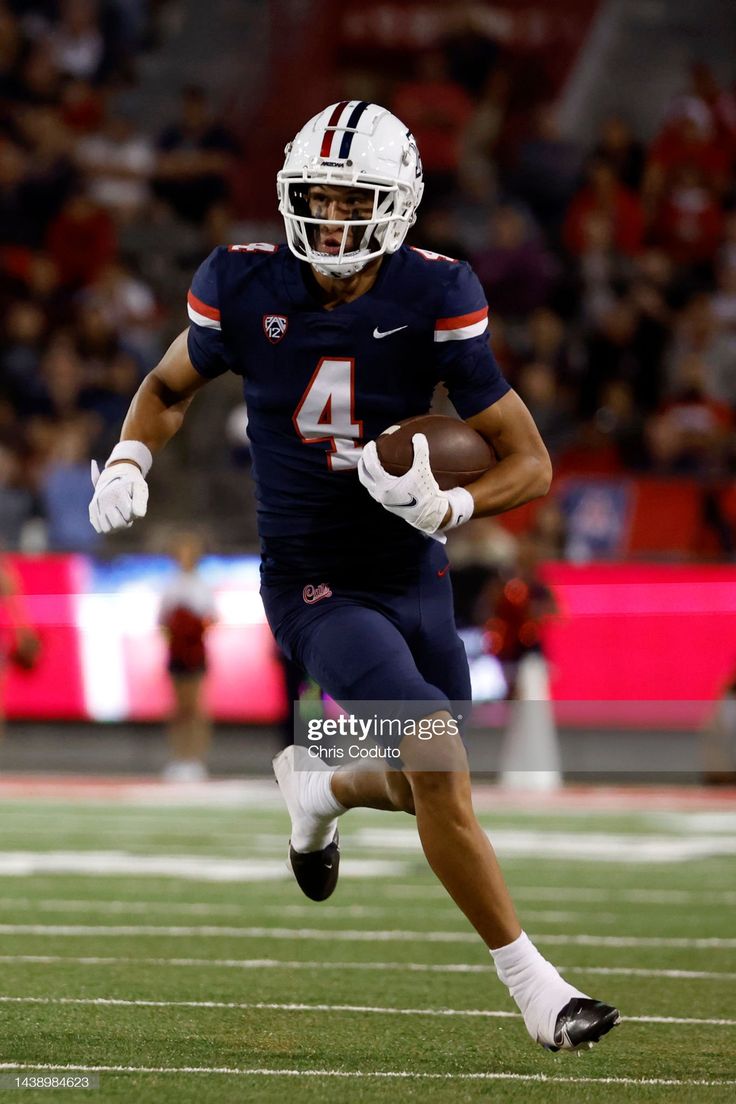 Wide receiver Tetairoa McMillan of the Arizona Wildcats runs during. Wide receiver, Gameday outfit, Football