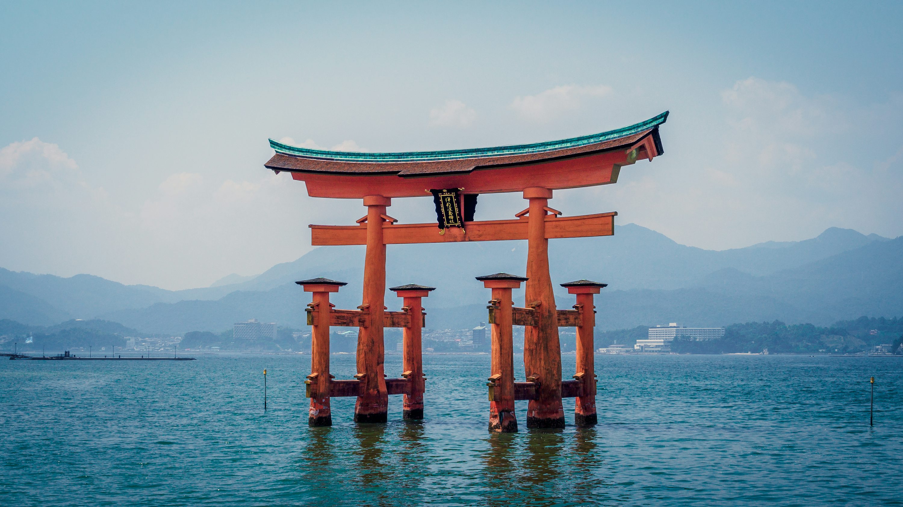 Red shrine in body of water photo