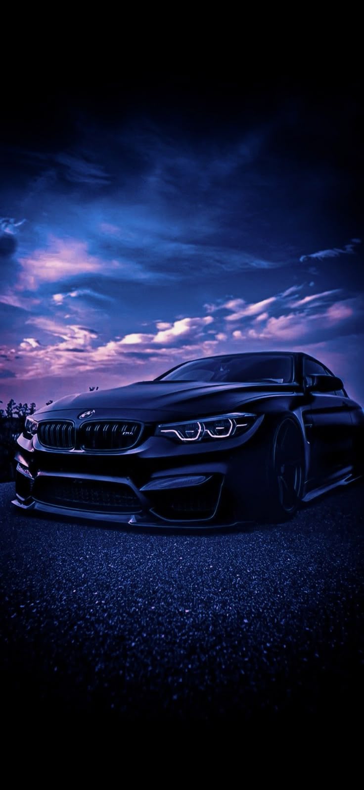 BMW M4 parked under a purple sky