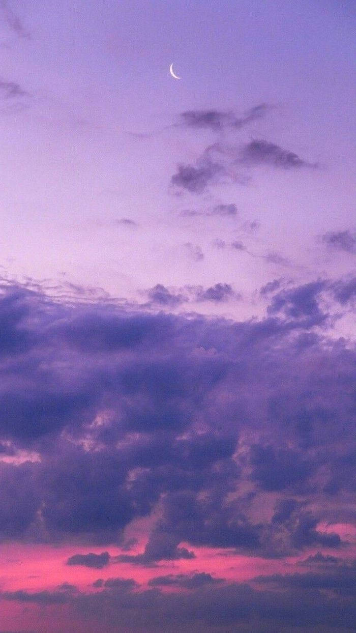 Download A Purple Sky With A Crescent And Clouds Wallpaper
