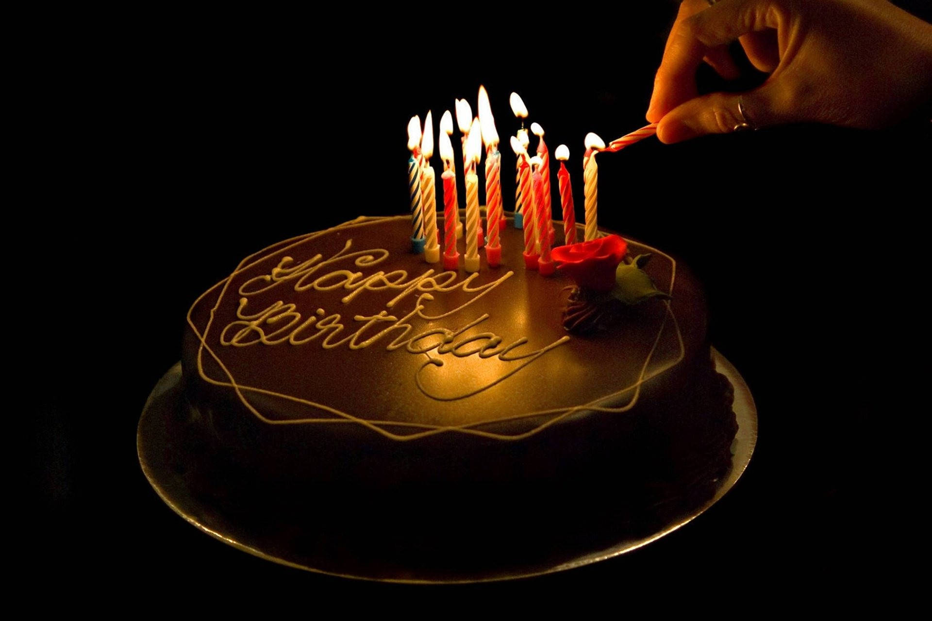 Download Dark Chocolate Birthday Cake Adorned with Lit Candles Wallpaper