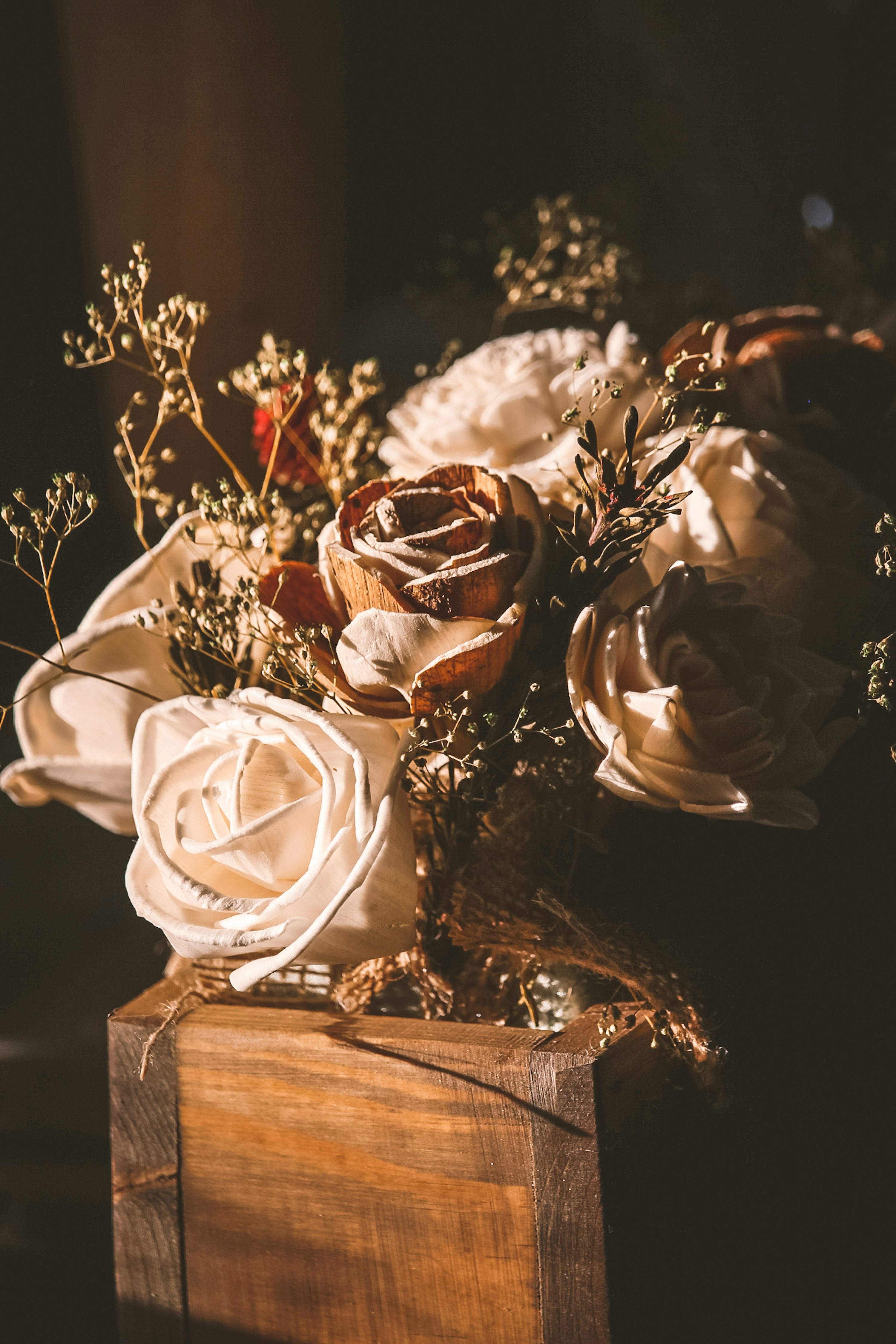 White rose bouquet on brown wooden table photo