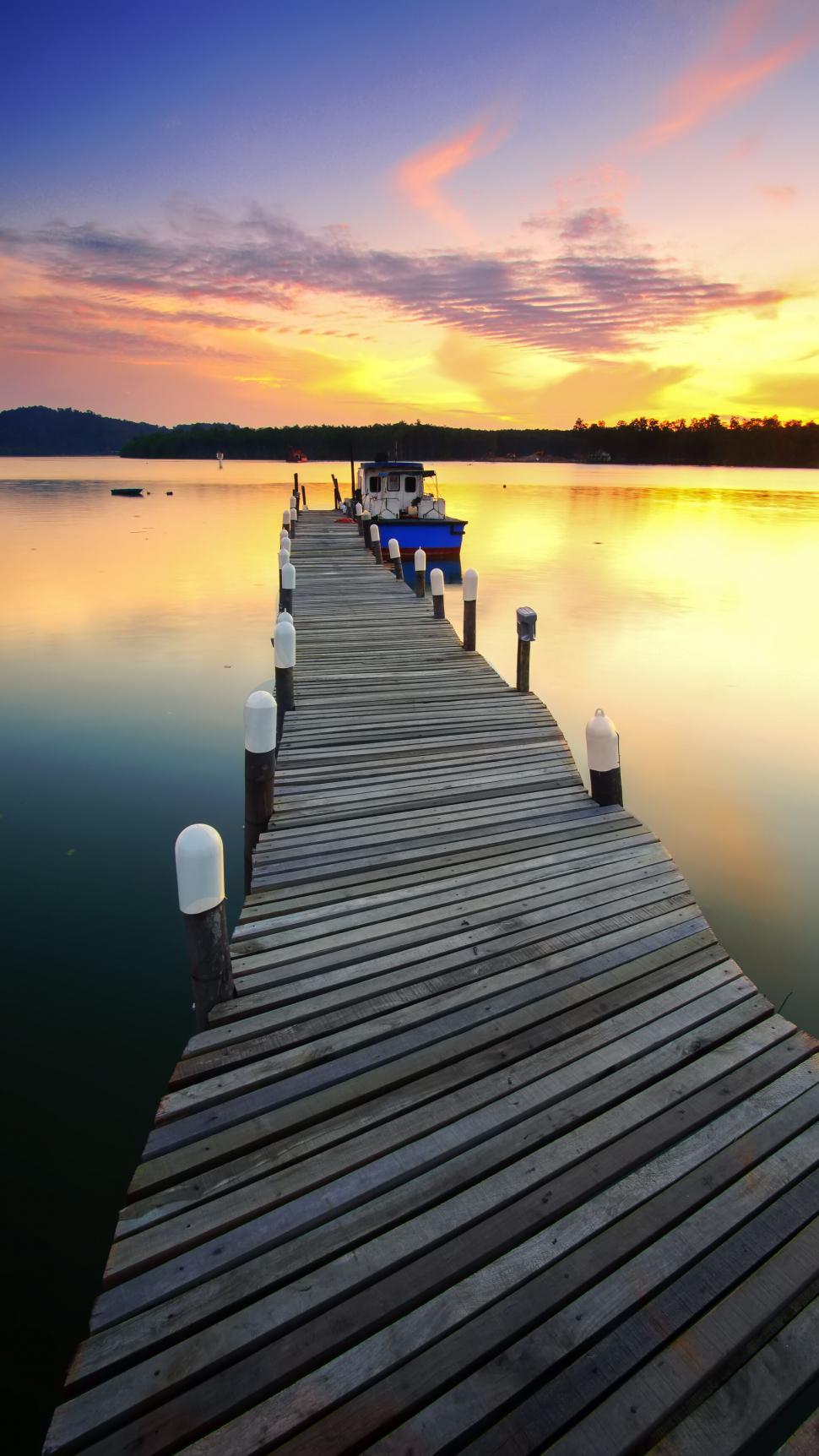 Free of Wooden jetty on a calm lake at sunset. Download Free Image and Free Illustrations
