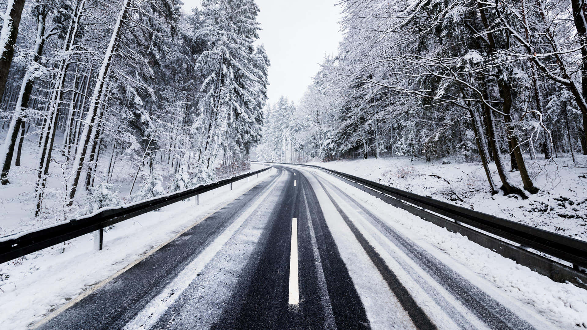 Download Winter Wonderland Snow Covered Icy Road Wallpaper