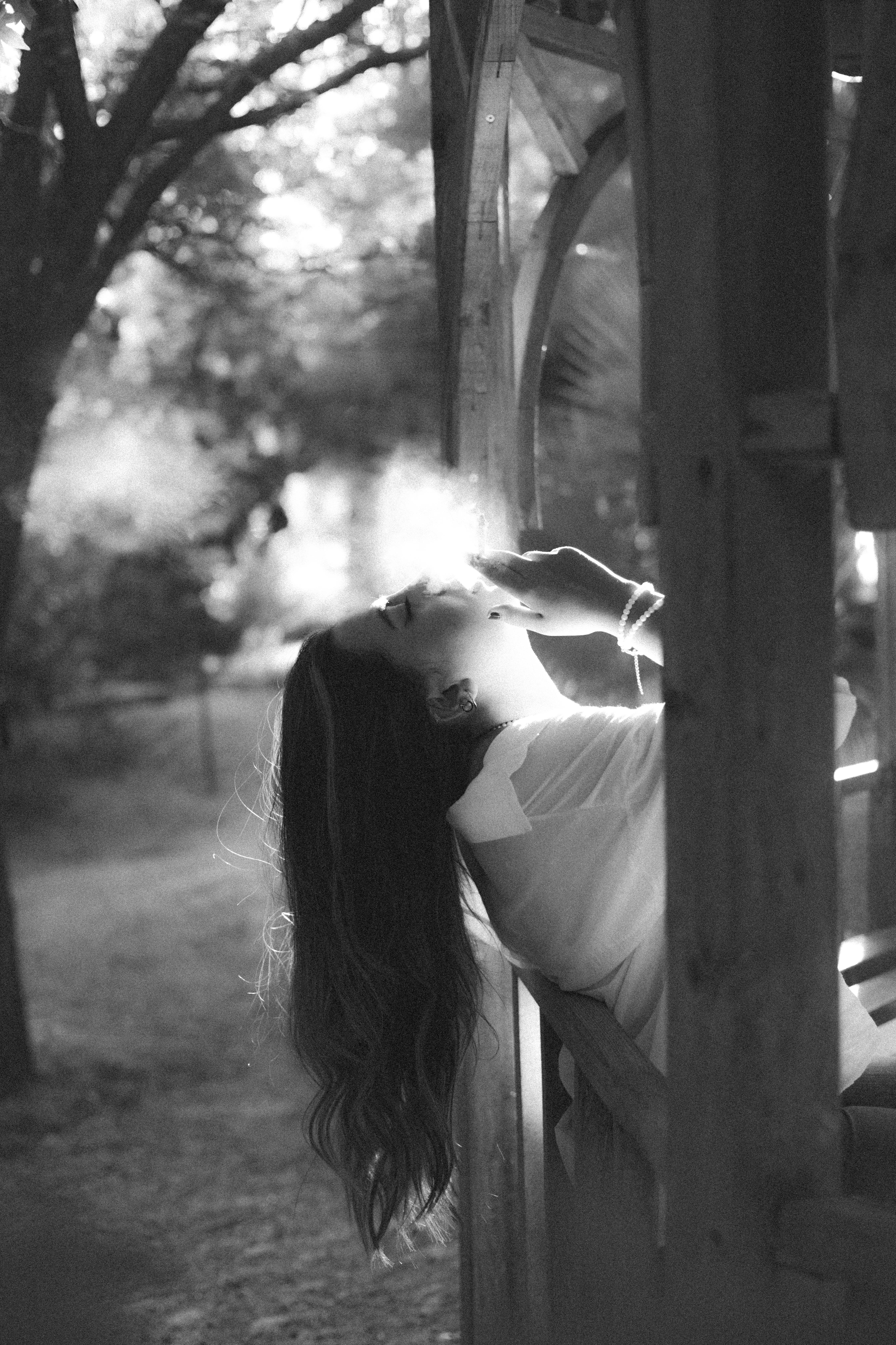 Black and White Photo of a Woman Smoking Cigarette with her Head Tilted Back · Free