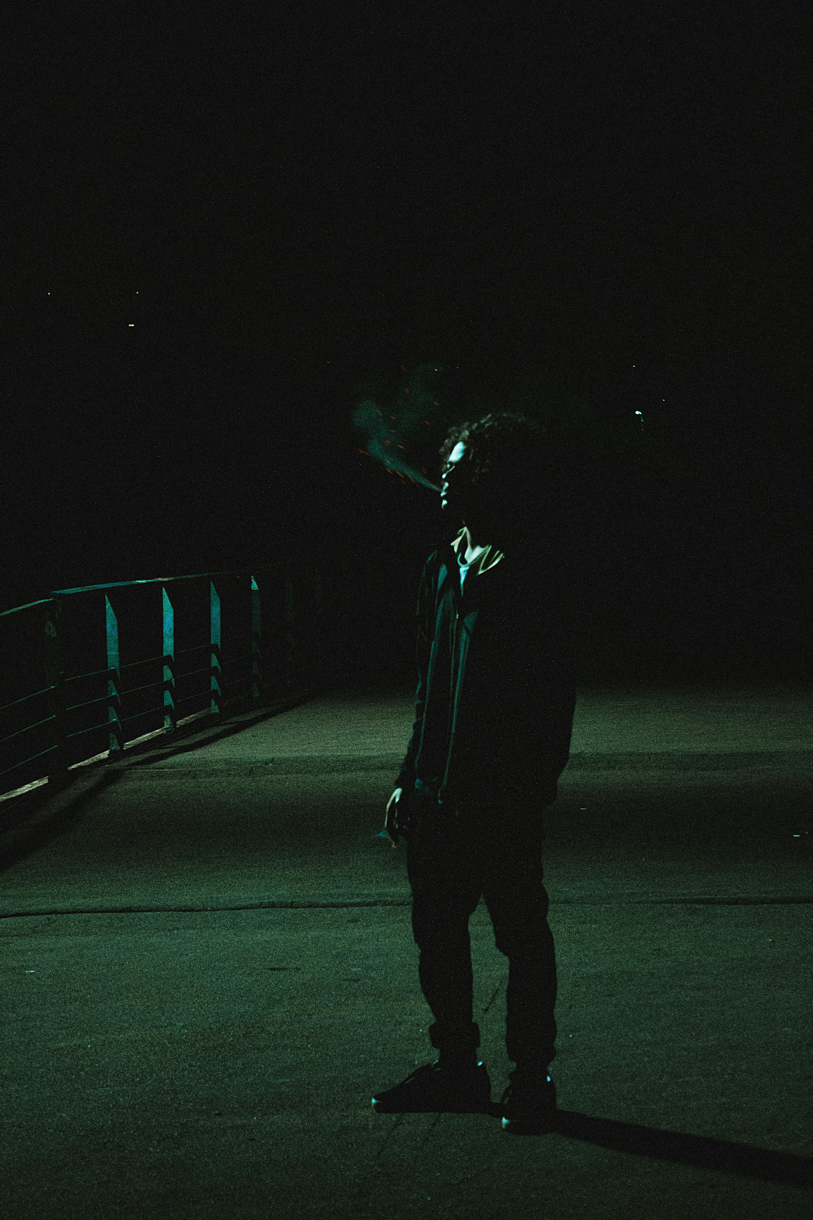 A Man Smoking Cigarette in the Darkness of the Night · Free