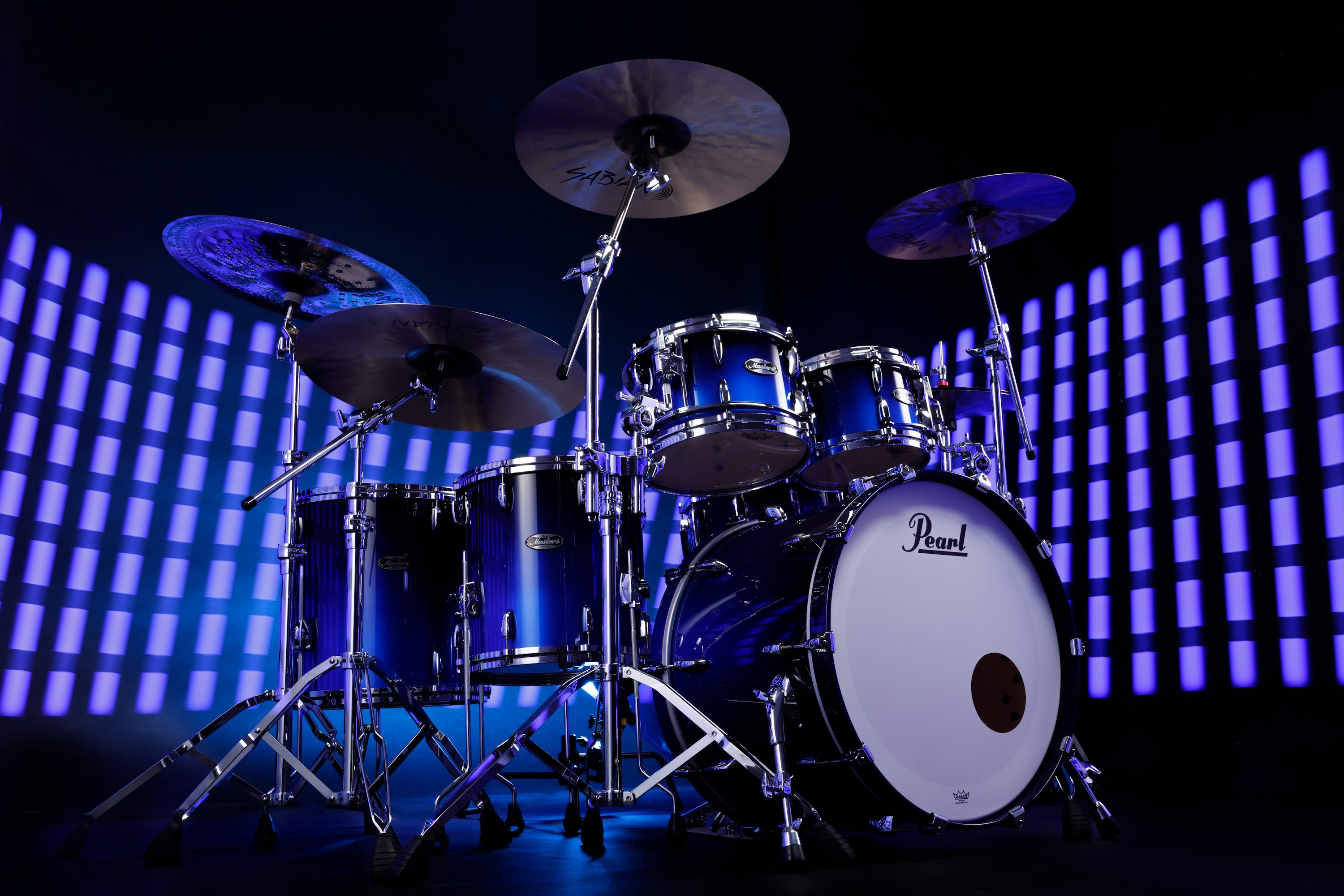 A drum set is shown in front of a blue background photo