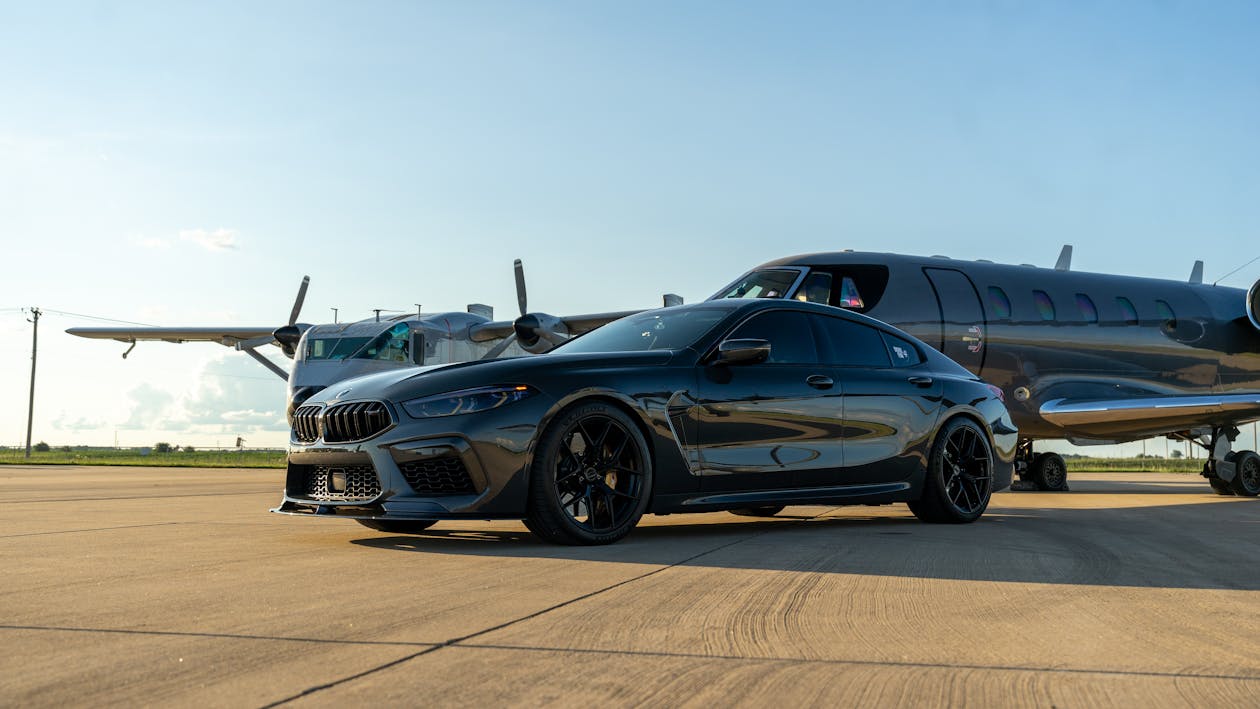 Luxury Car and Private Jet on Airport Tarmac · Free