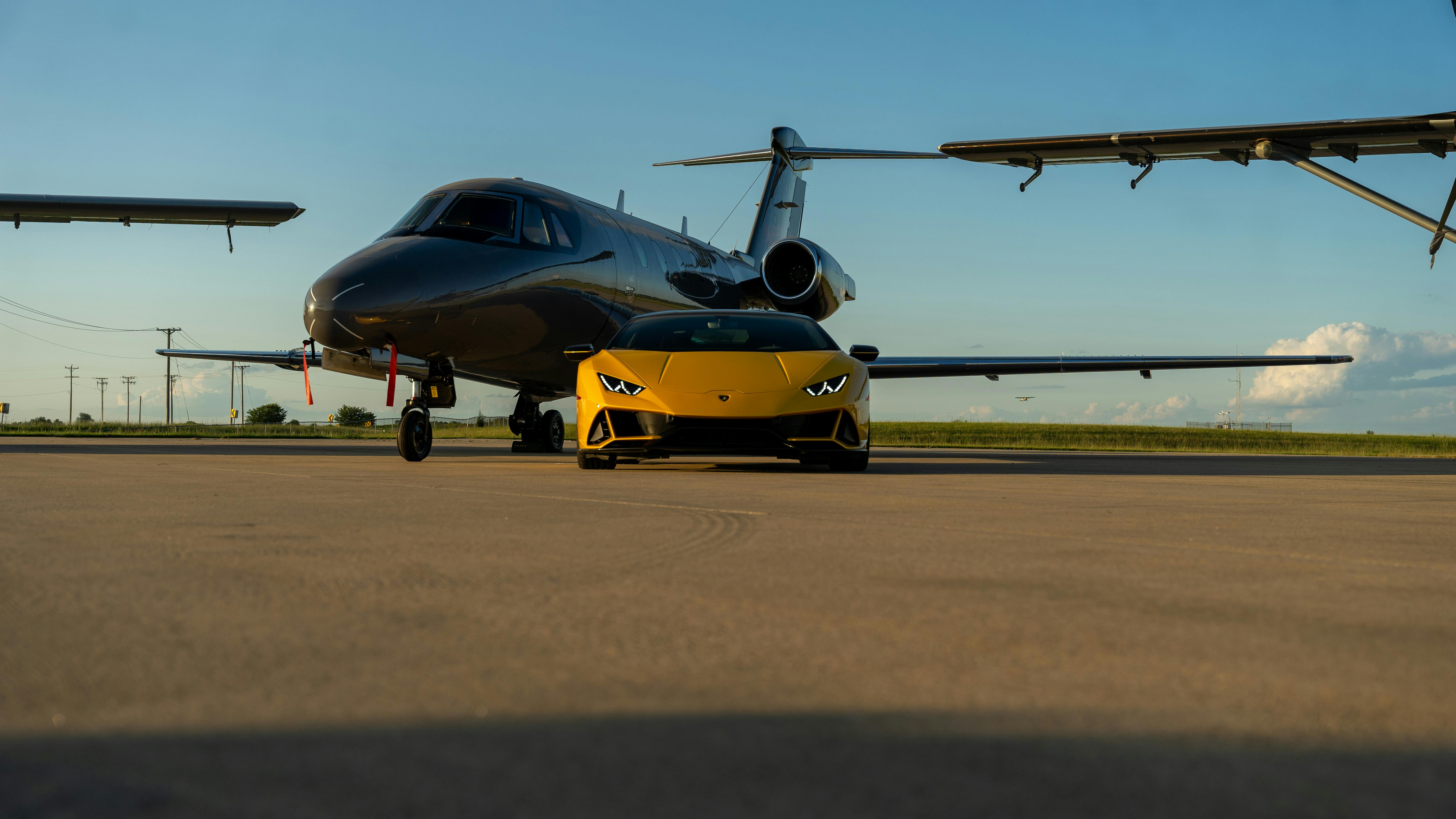 Luxury Sports Car and Private Jet on Tarmac · Free