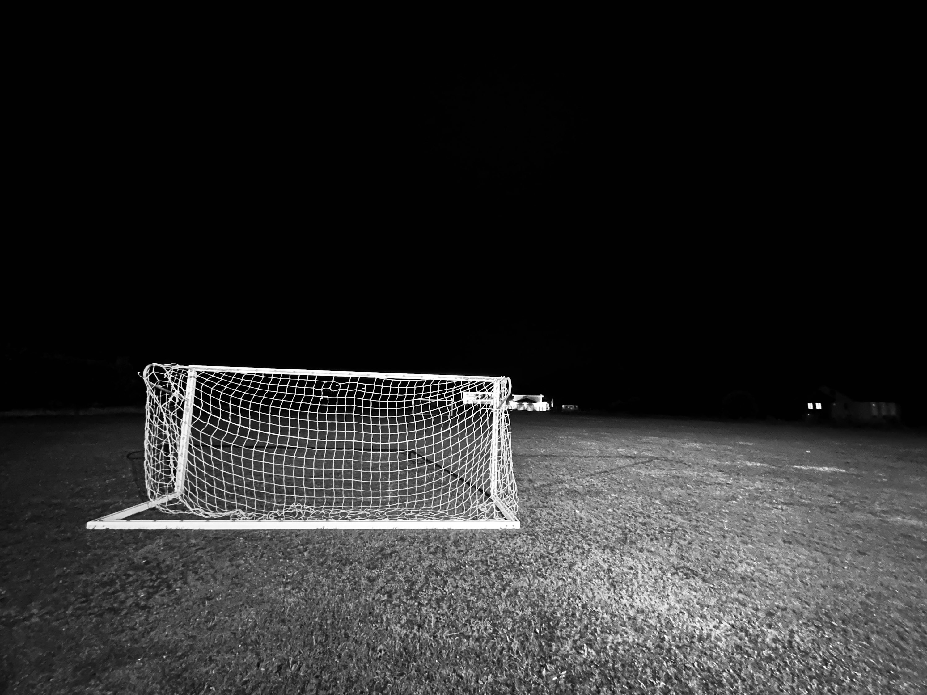 A black and white photo of a soccer goal photo