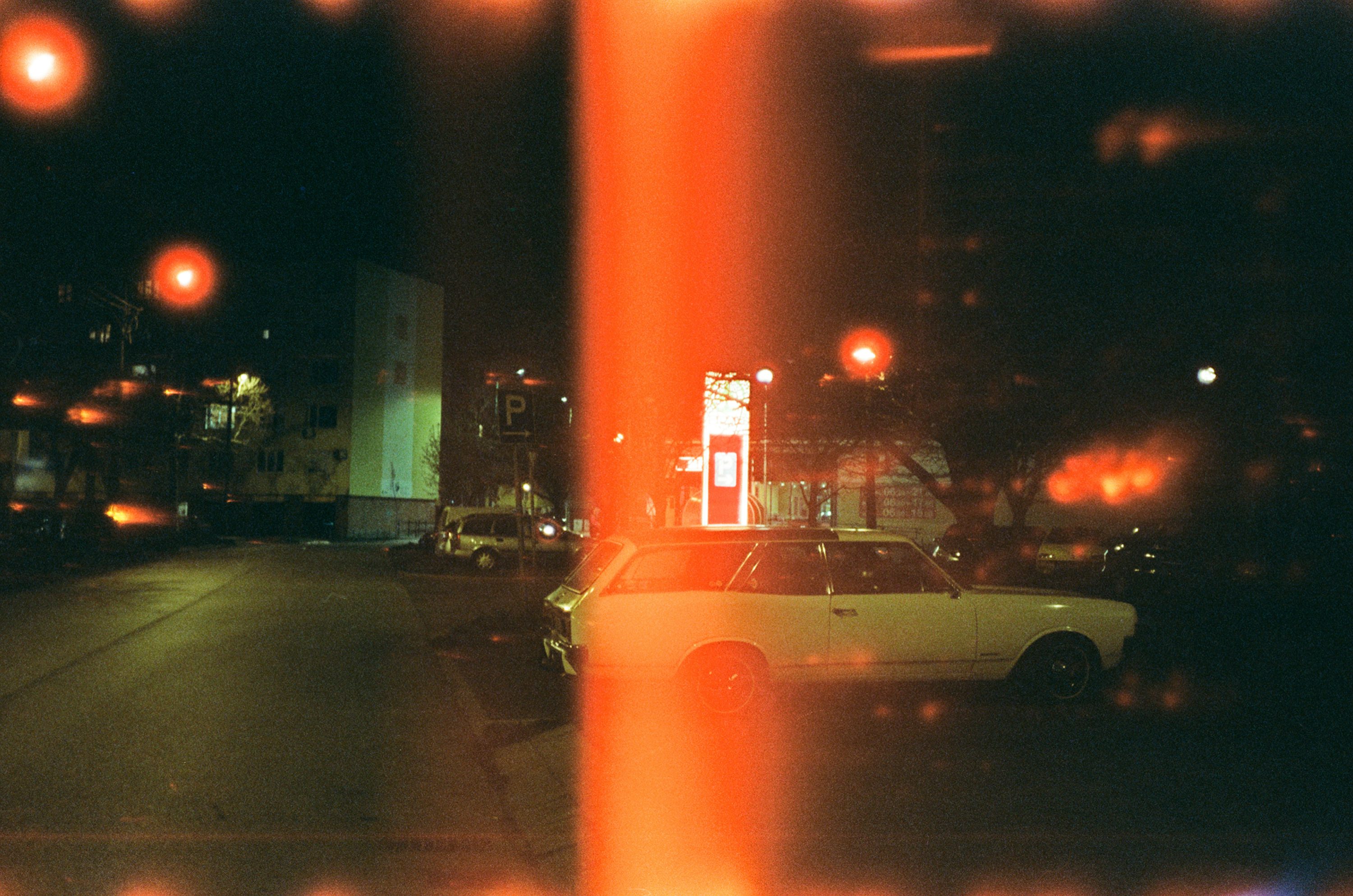 White sedan on road during night time photo