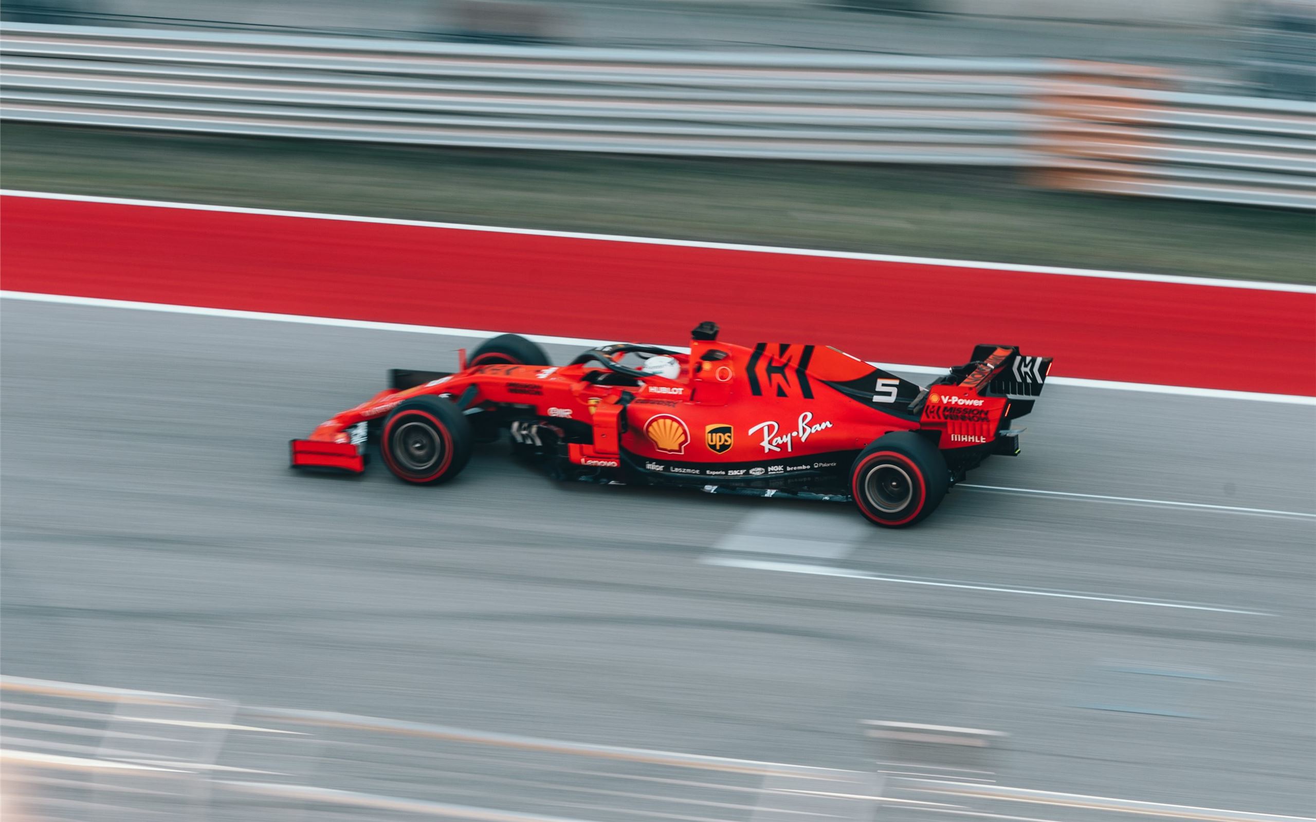 selective focus photography of red Formula 1 on tr Mac Wallpaper Download