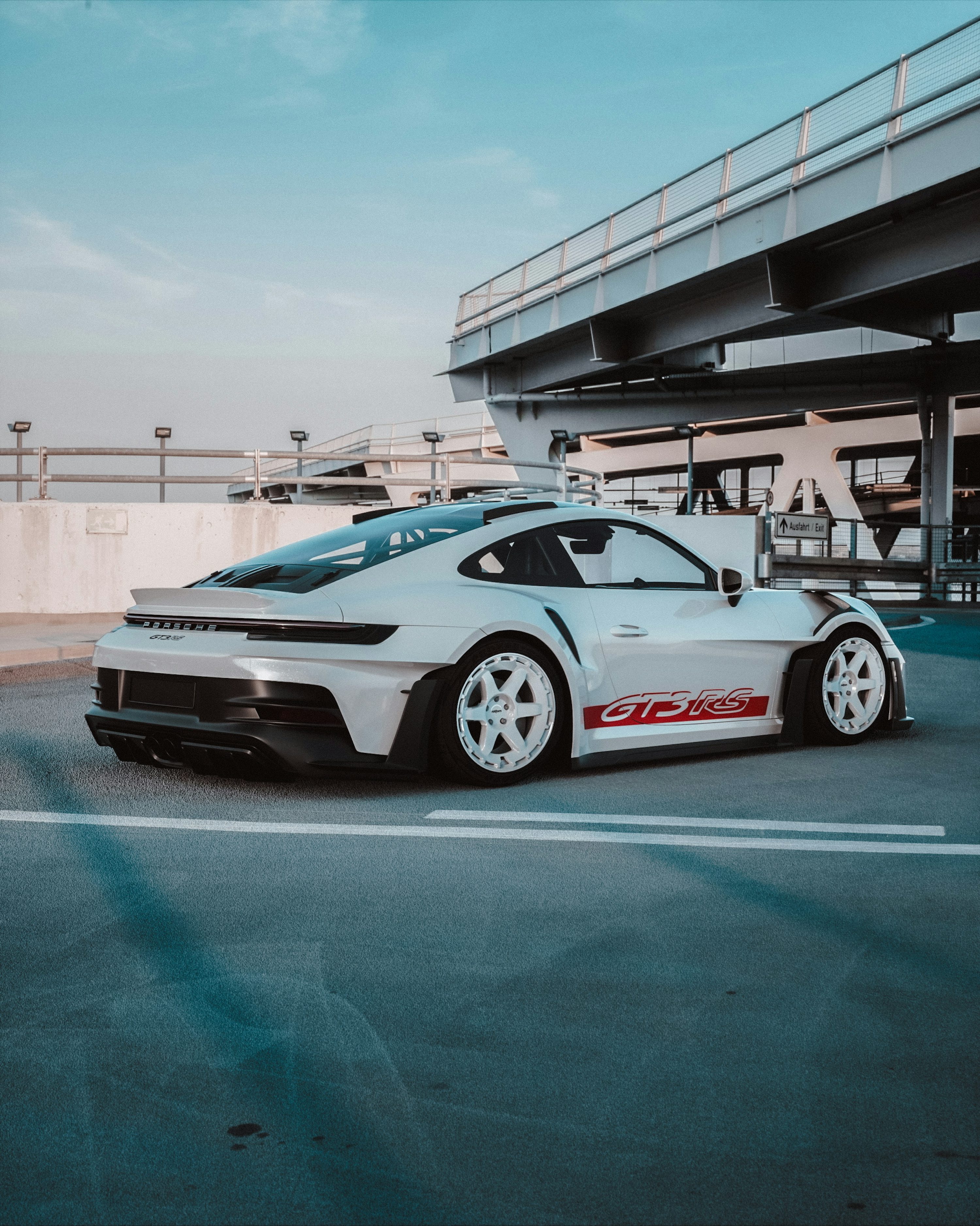 White porsche sports car parked in a parking garage. photo