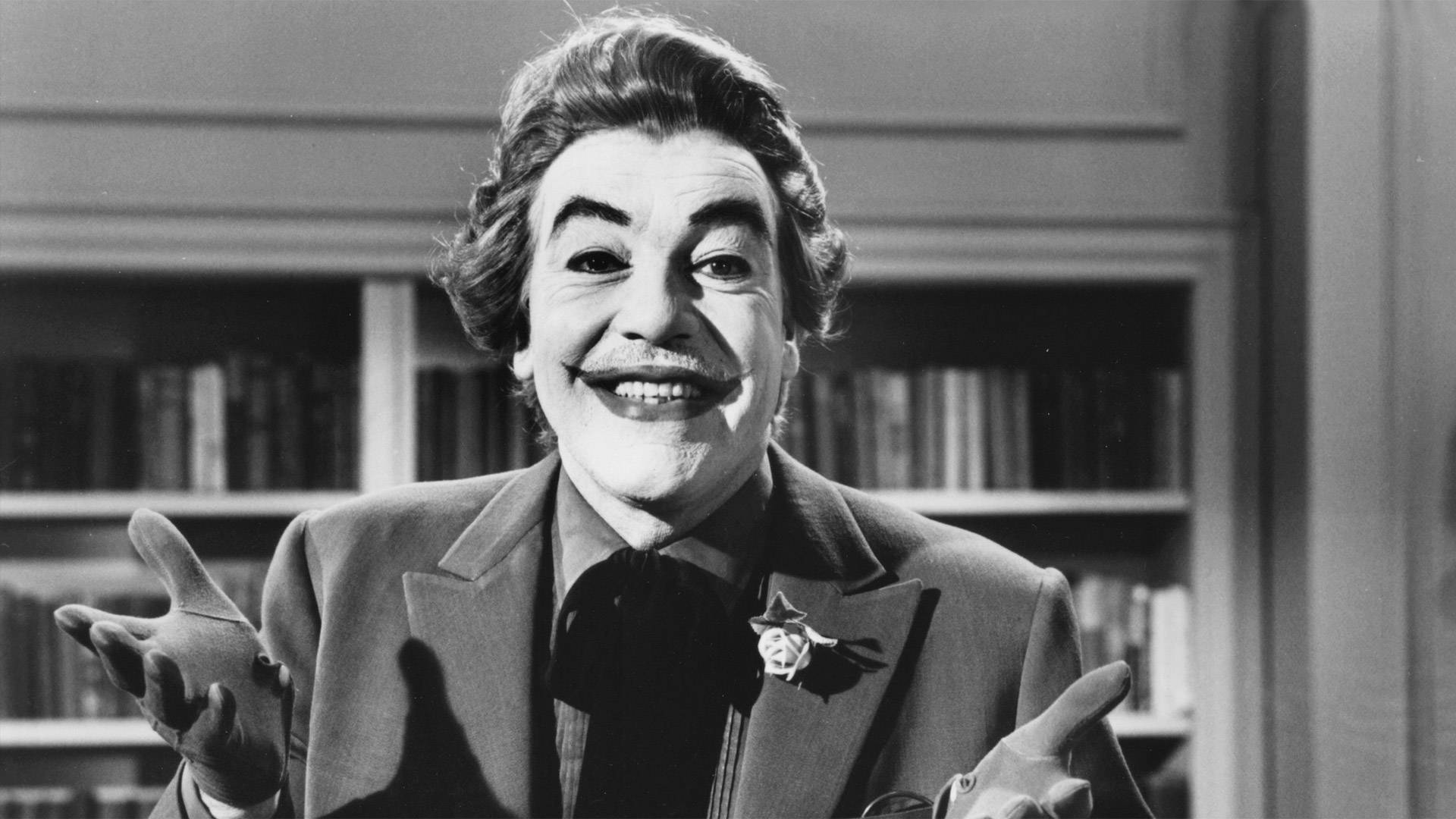 Download Smiling With Hand Gestures Cesar Romero Wallpaper