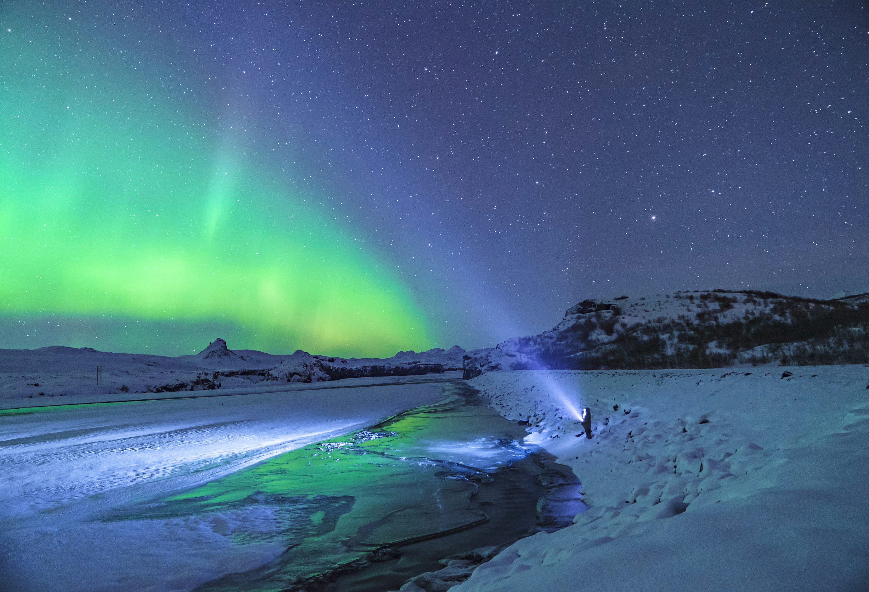 Person standing under aurora lights photo