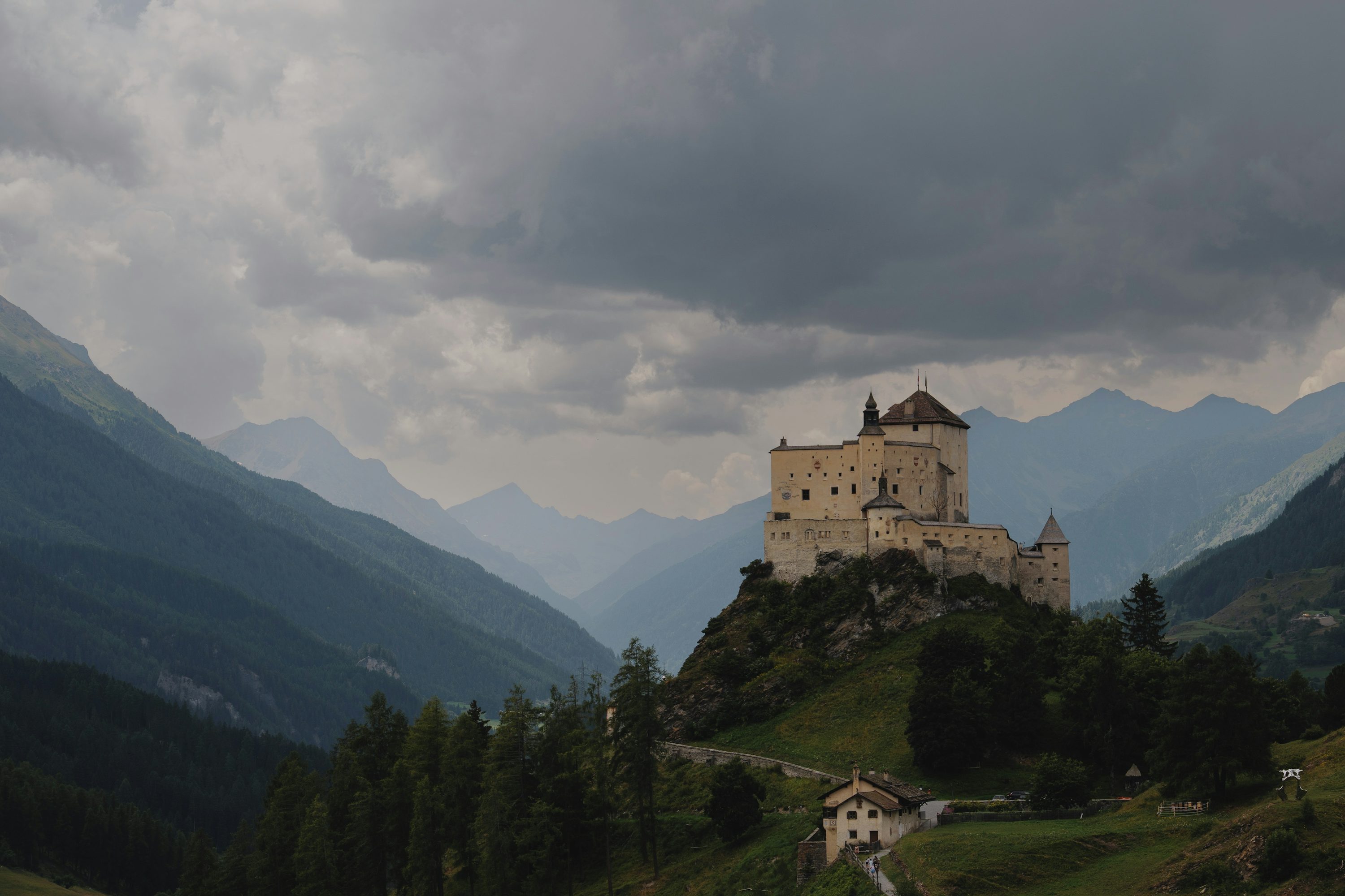 A castle sits atop a mountain. photo