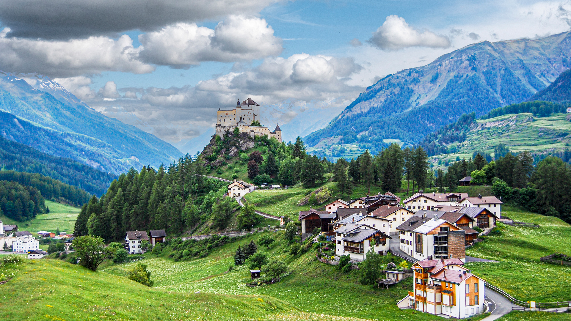 Tarasp Castle on a conical rocky hill in Scuol, Lower Engadin, Graubünden, Switzerland. Windows Spotlight Image