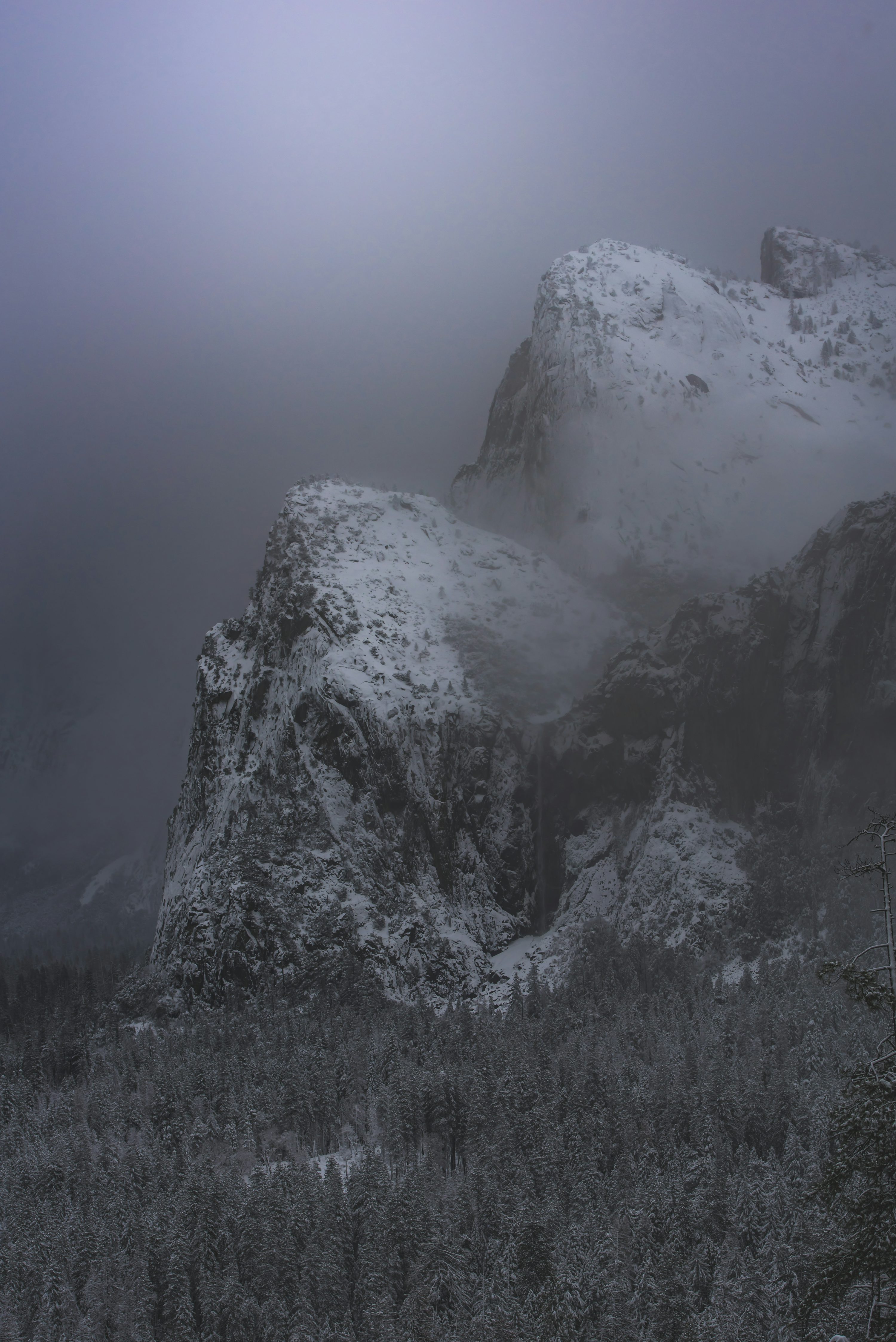 Snow covered mountain under cloudy sky photo