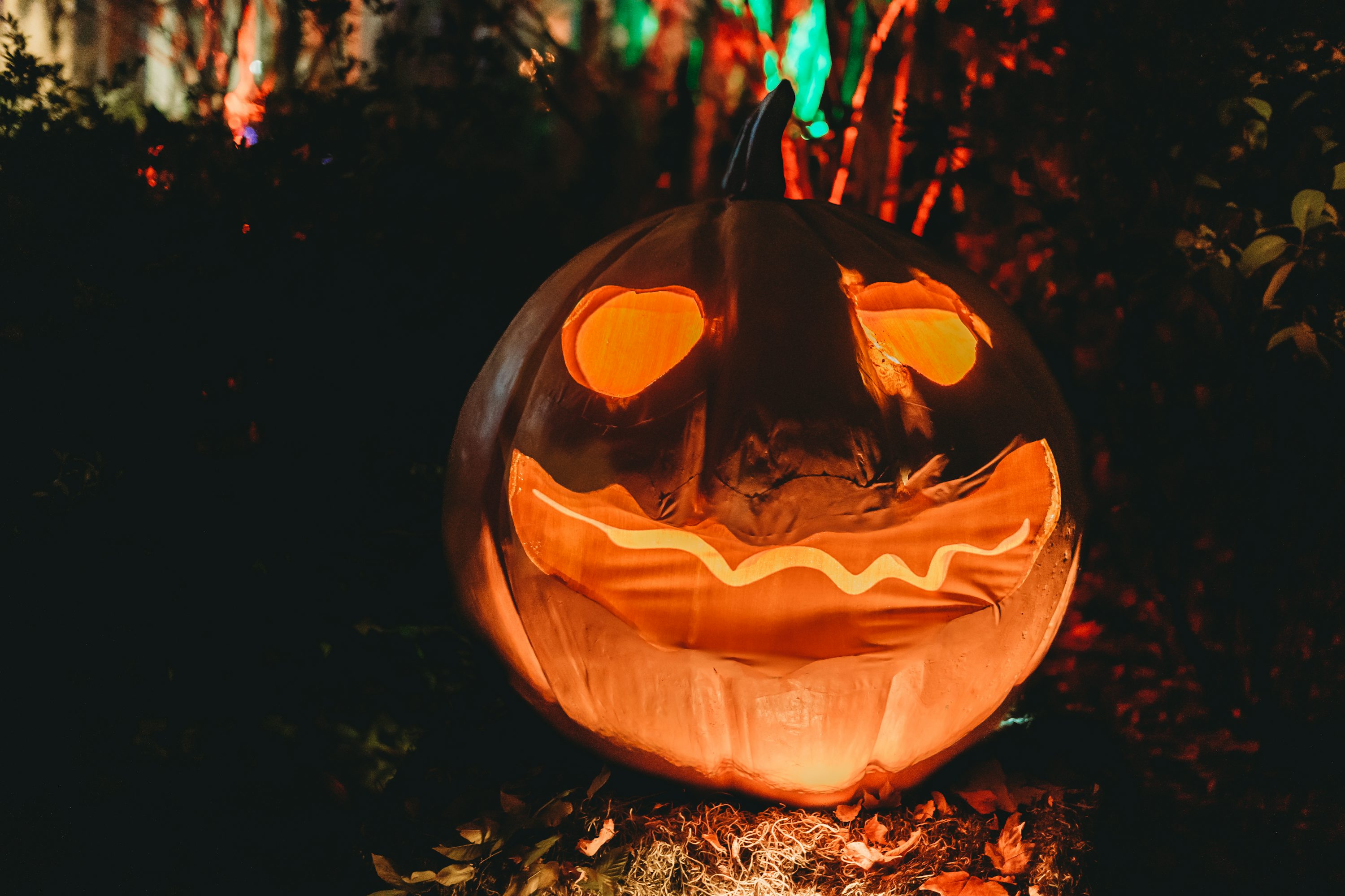 A carved pumpkin in the dark photo