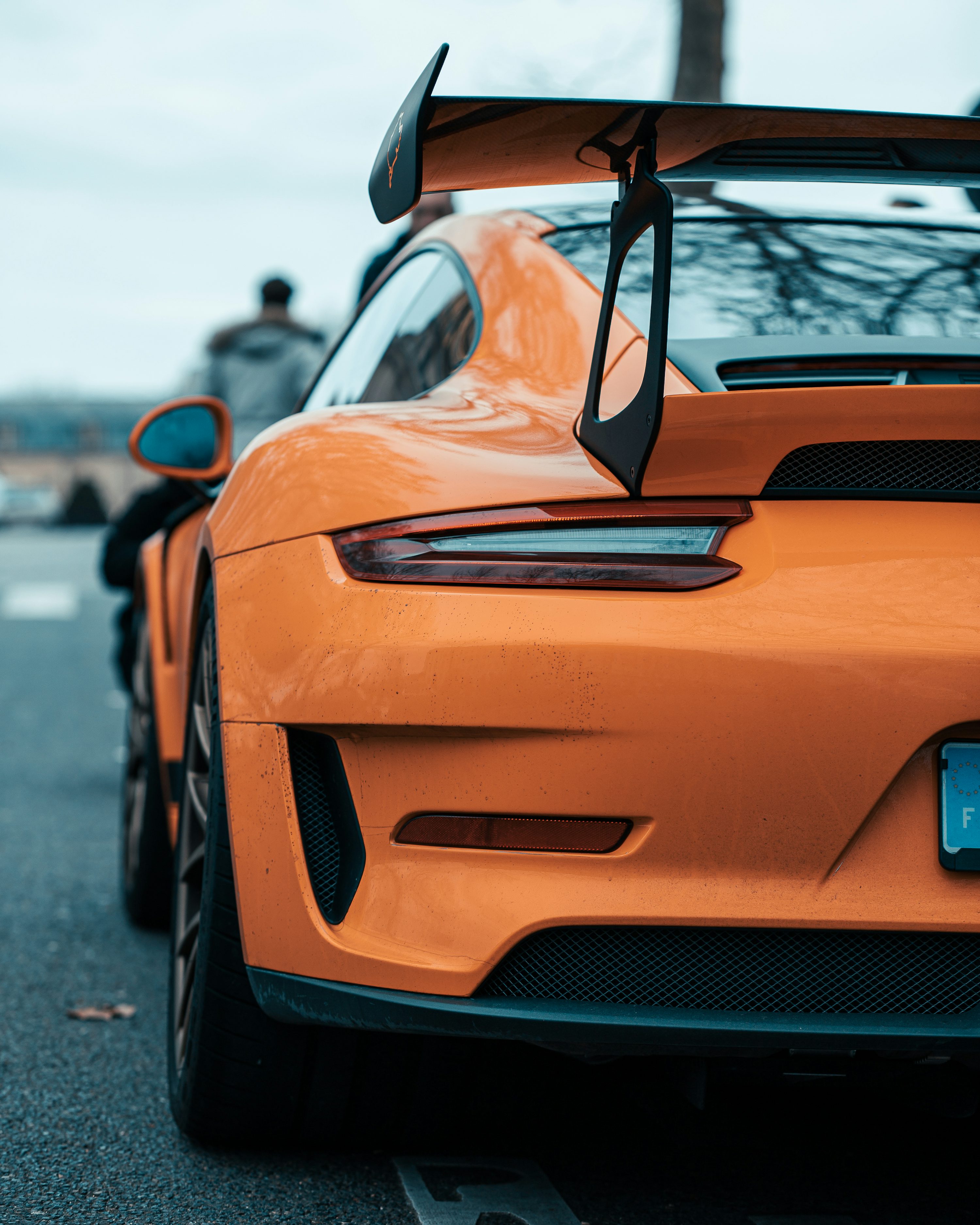 An orange sports car parked on the side of the road photo