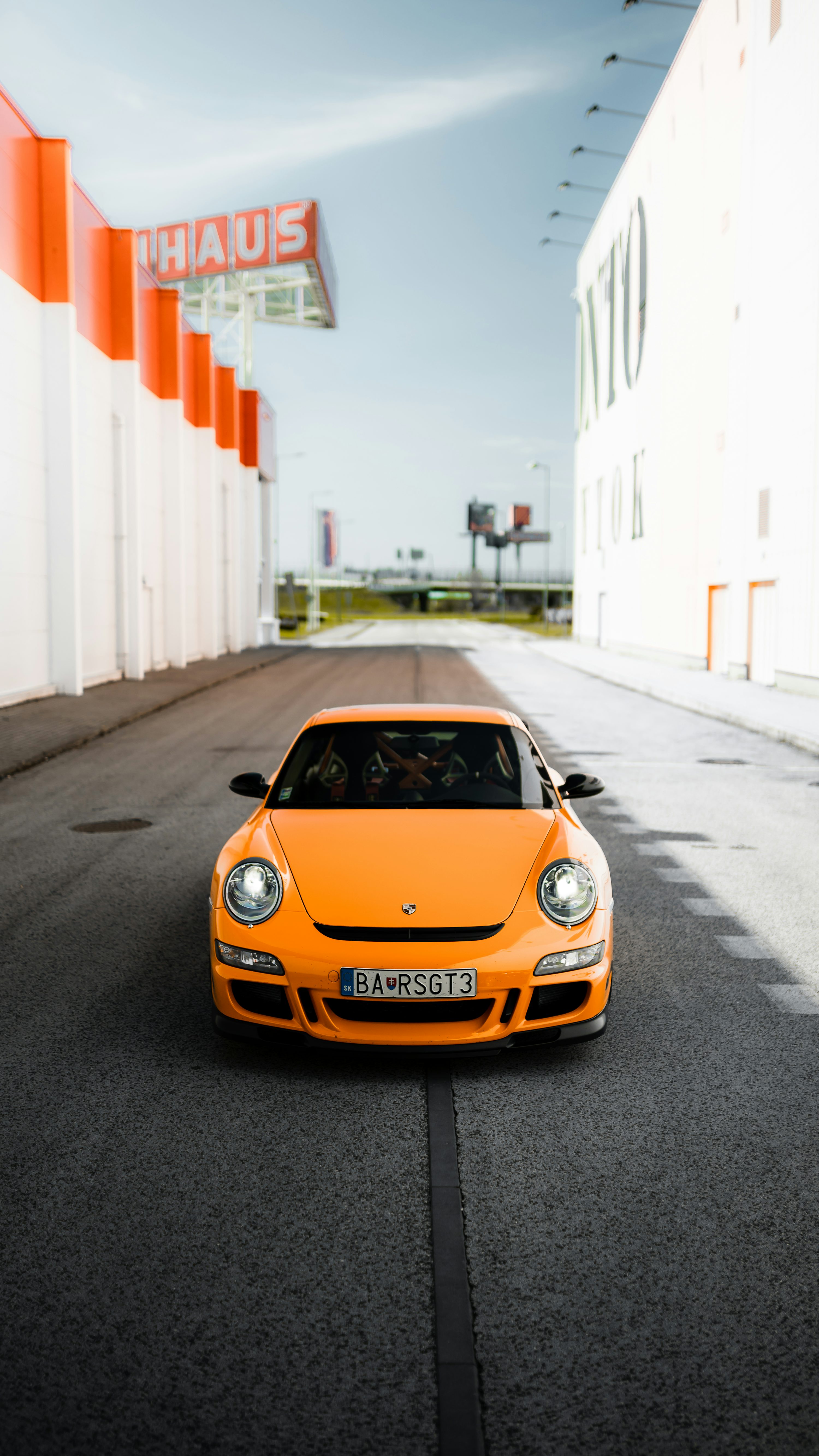 Orange porsche 911 on road during daytime photo