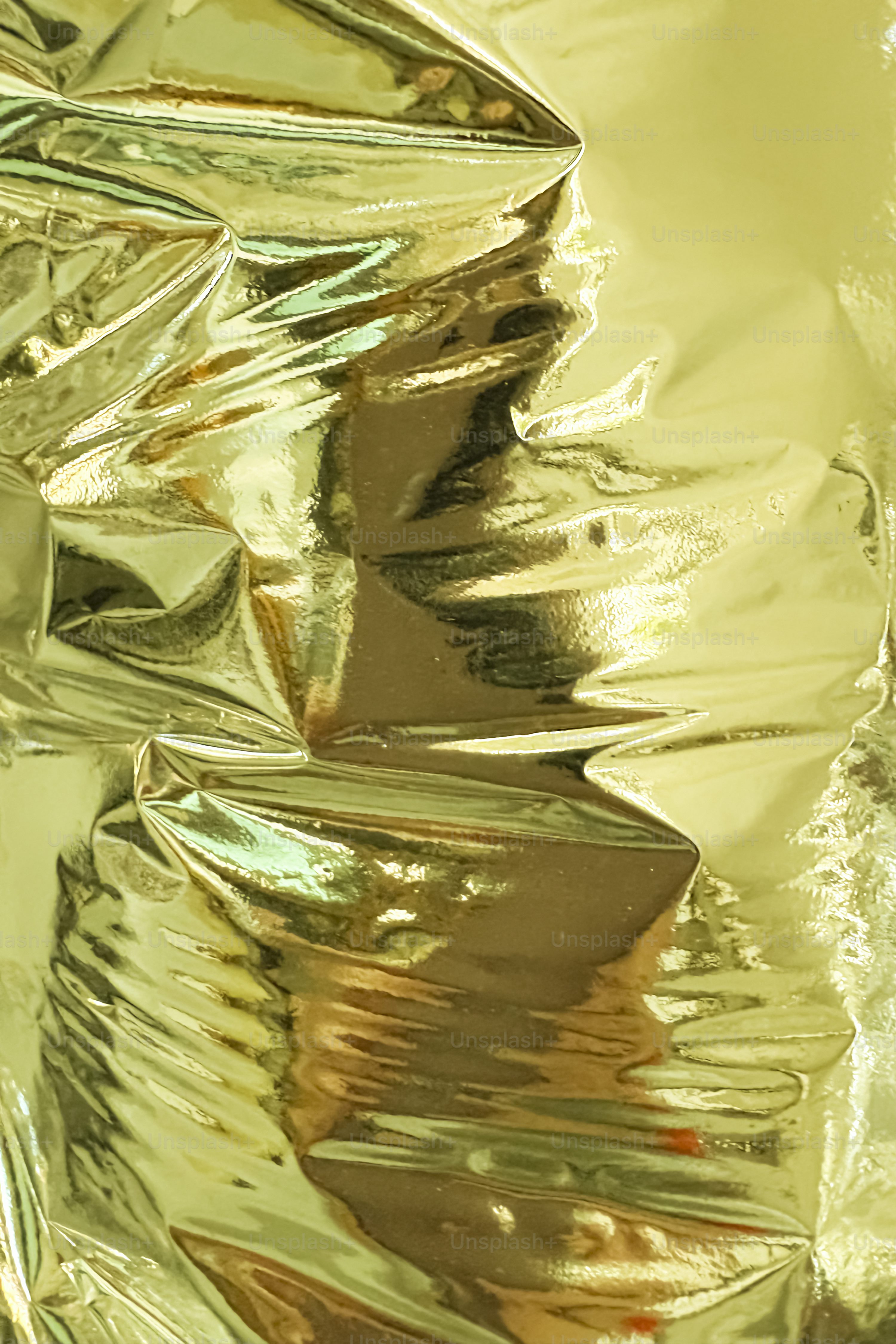 Wrinkled golden foil creates a shiny, textured background. photo
