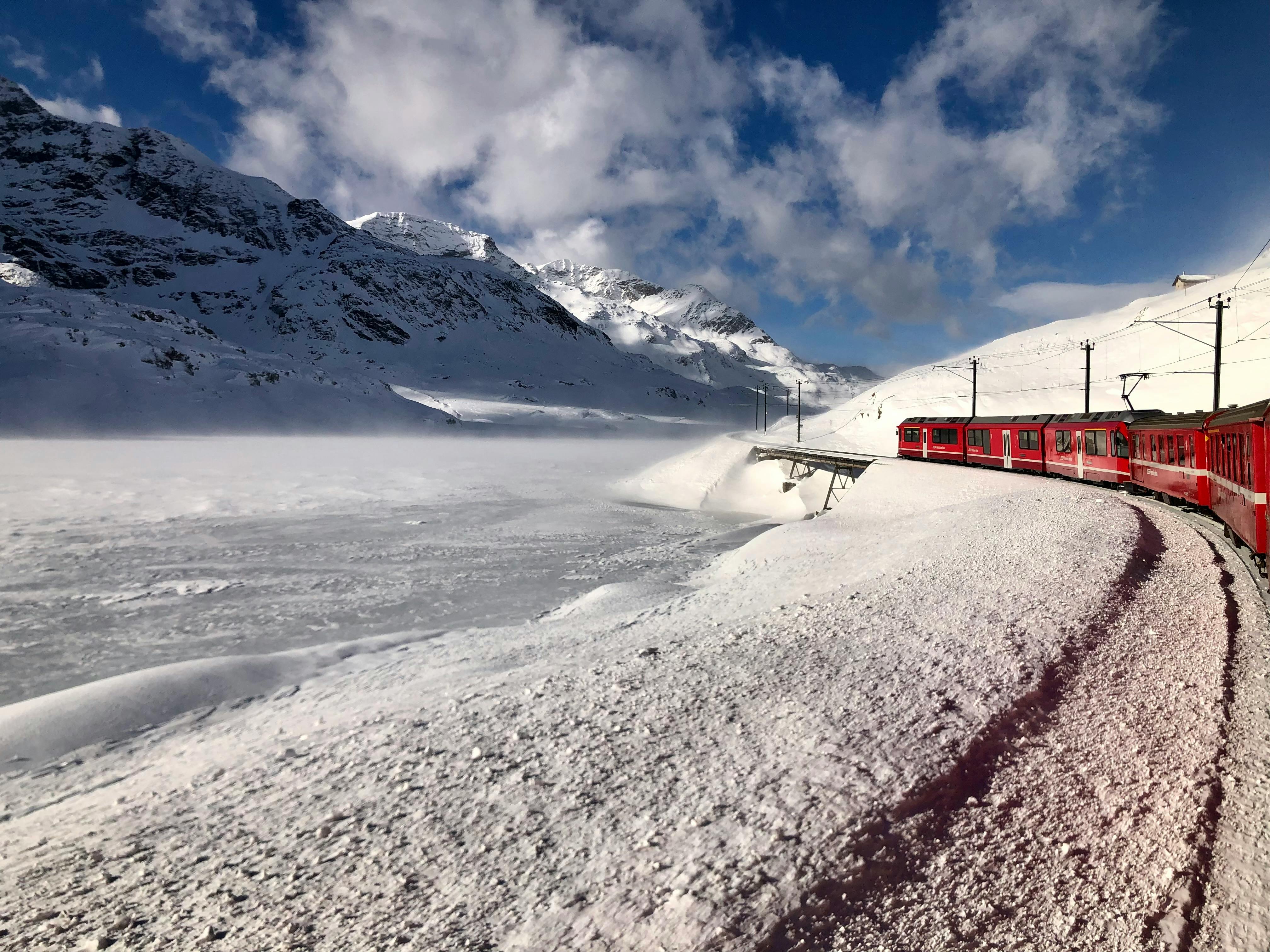 Red and Black Train Running Along Snow Covered Field · Free