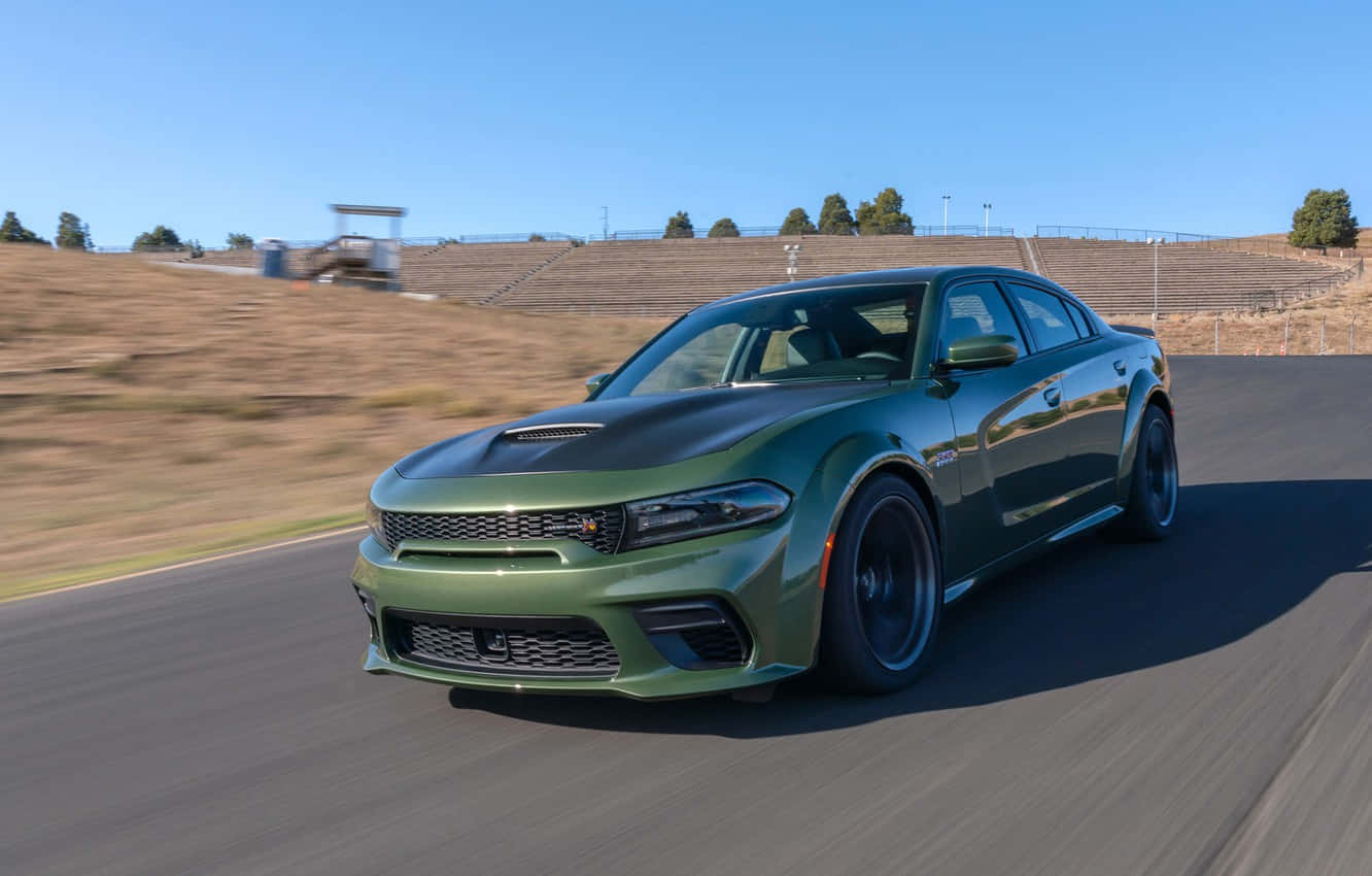 Download The Green 2019 Dodge Charger Srt Driving On A Race Track Wallpaper