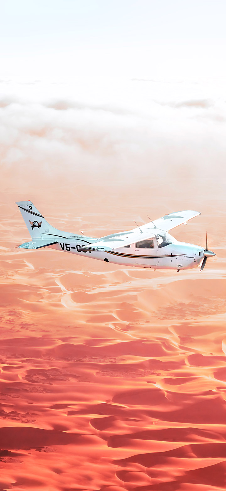 White Airplane Flying Over The Desert 4K Phone Wallpaper