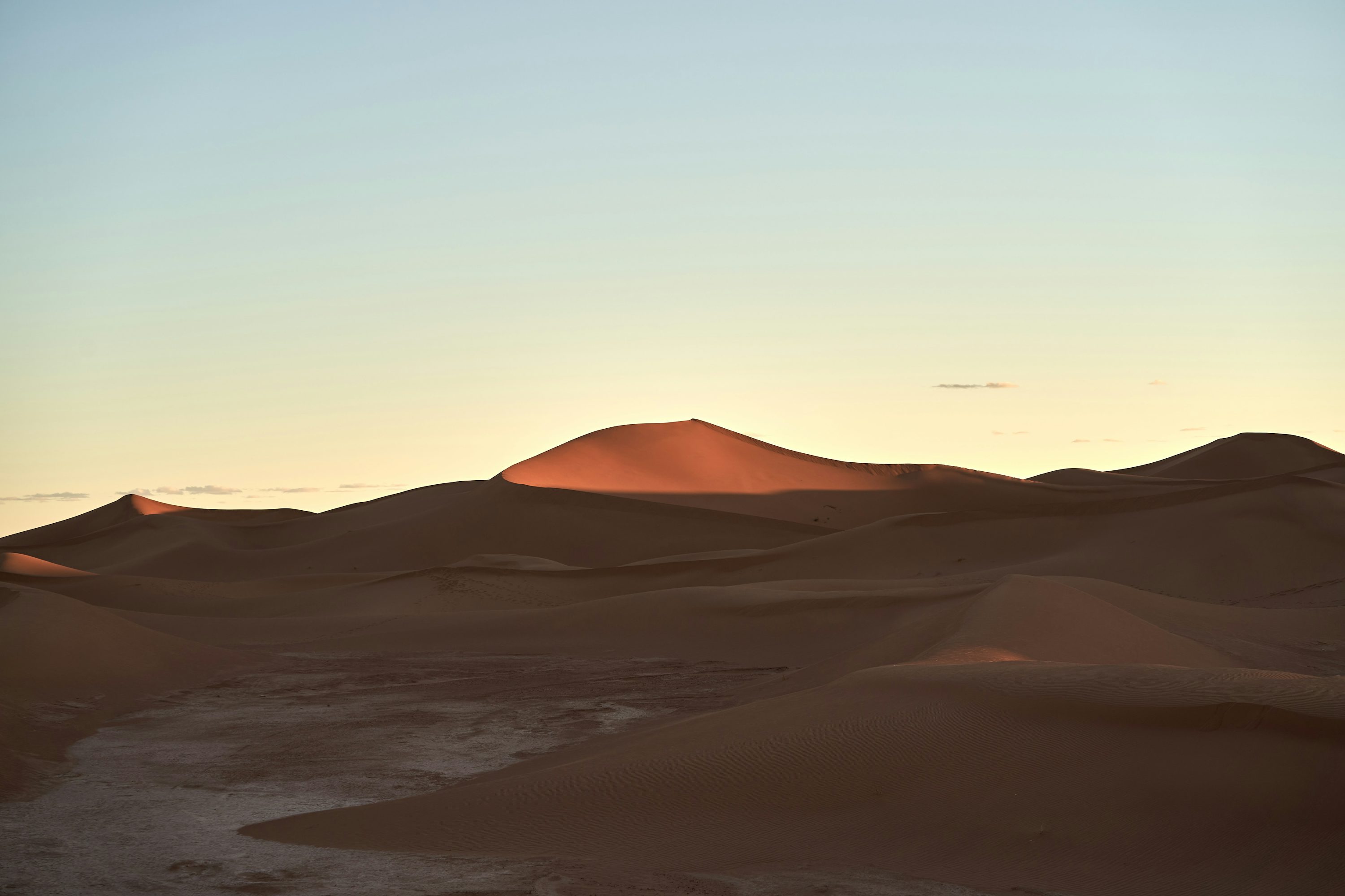 The sun is setting in the distance over the desert photo