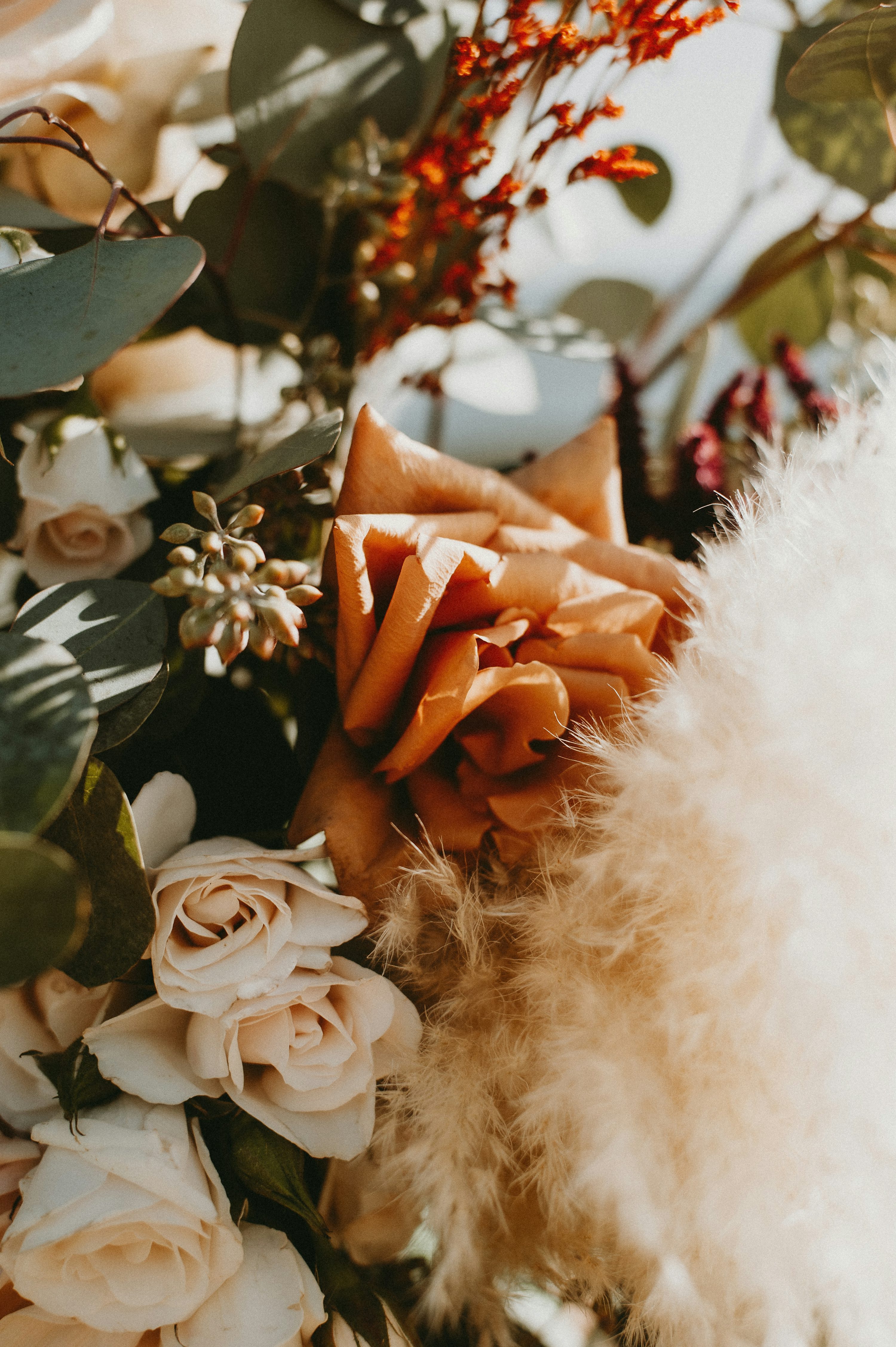 A close up of a bouquet of flowers and feathers photo
