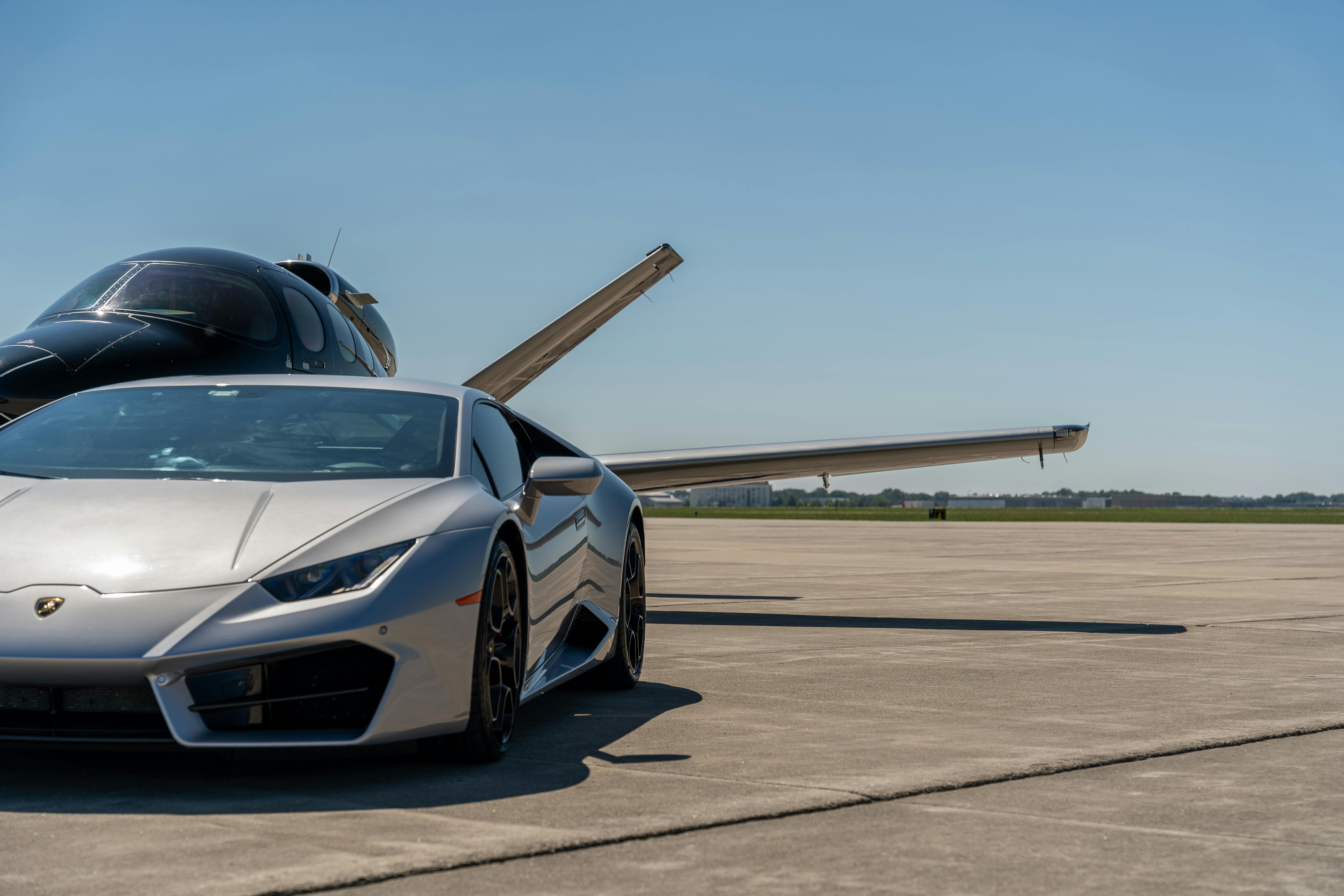 Luxury Sports Car and Private Jet on Runway · Free