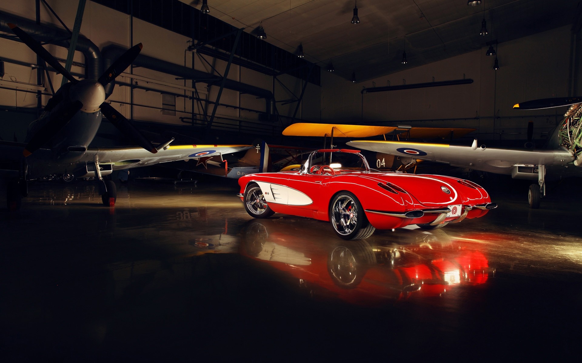 An old chevrolet supercar near the plane