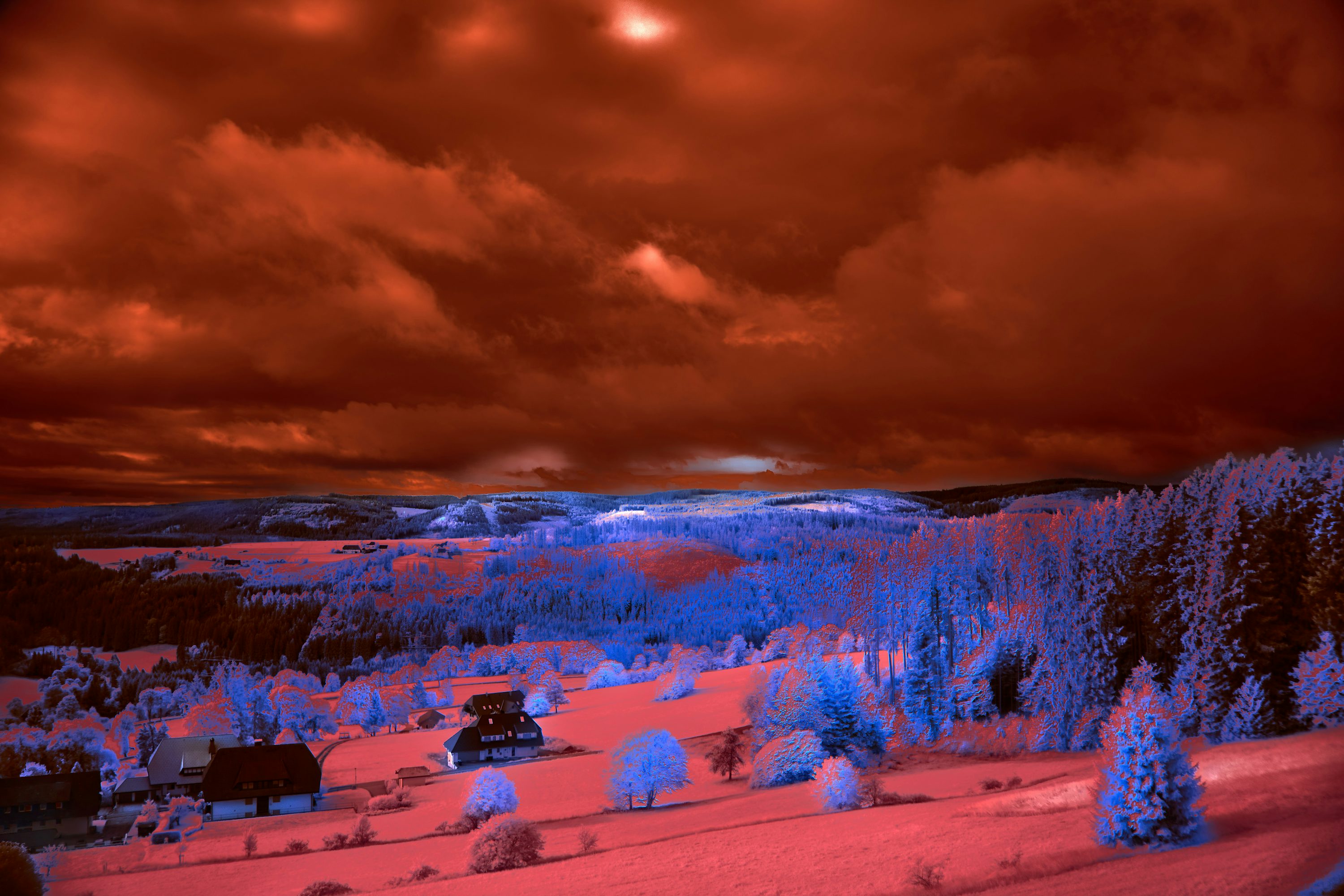 A red and blue infrared image of a snowy landscape photo
