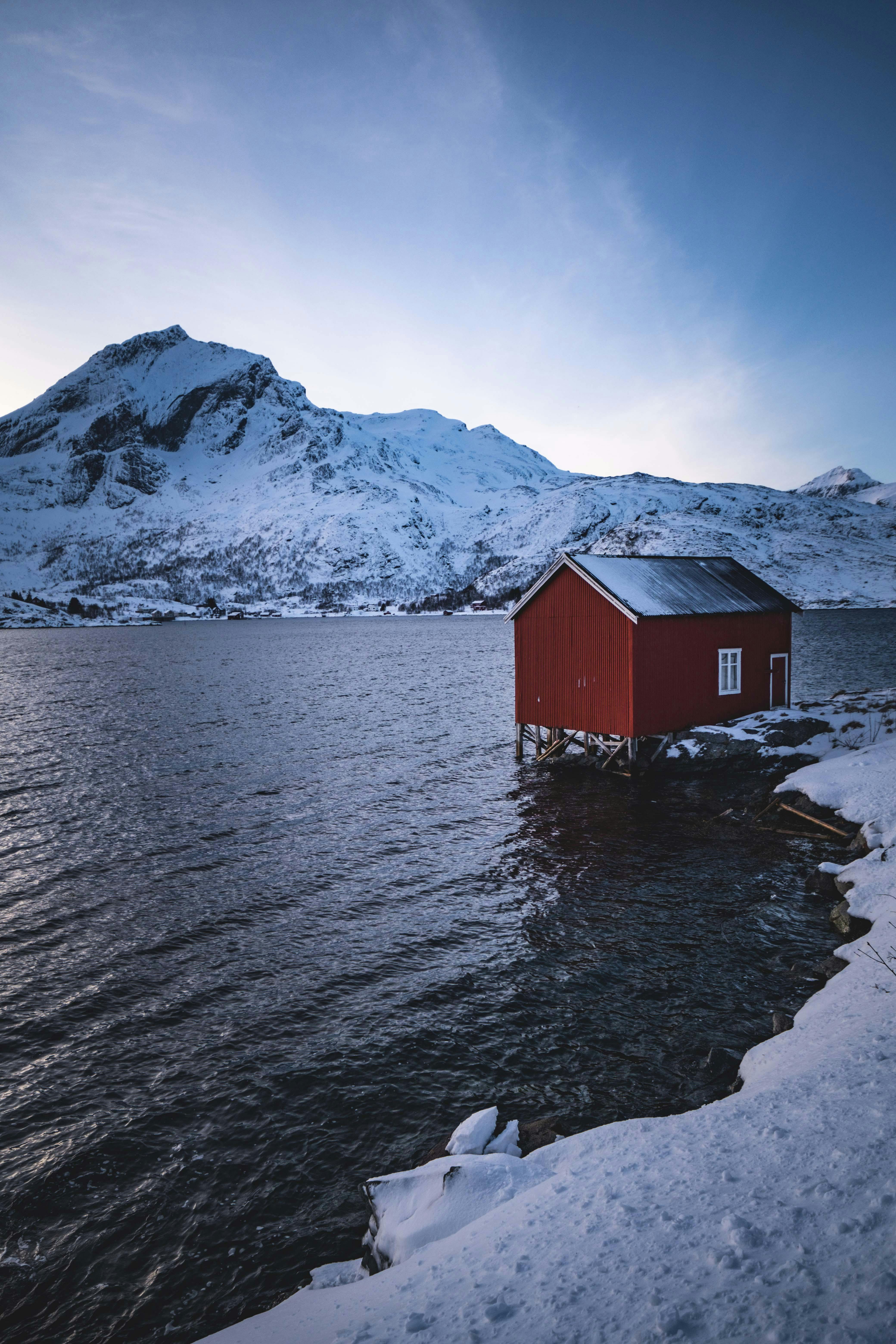 Scenic Winter Landscape with Red Cabin · Free