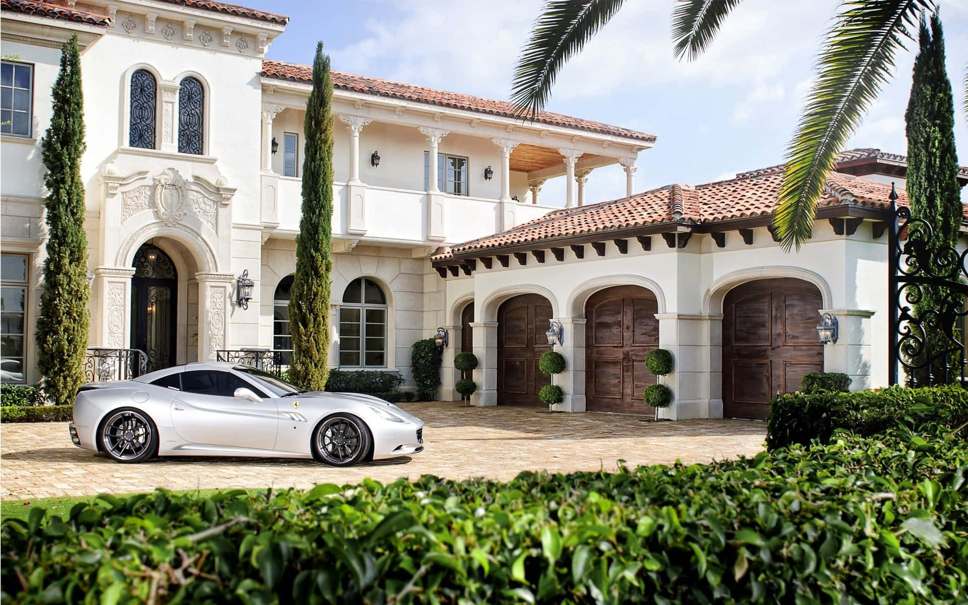 Download A White Sports Car Parked In Front Of A Mansion