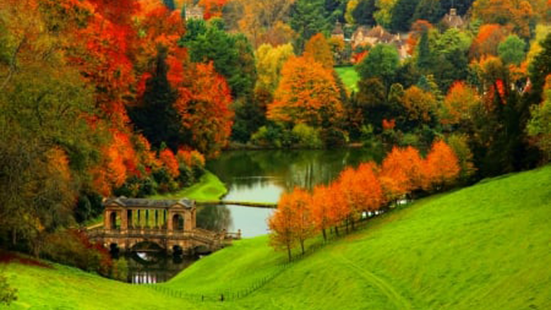 Landscape View Of Architecture Building Between River Colorful Autumn Trees Green Grass Slope Field HD Autumn Wallpaper