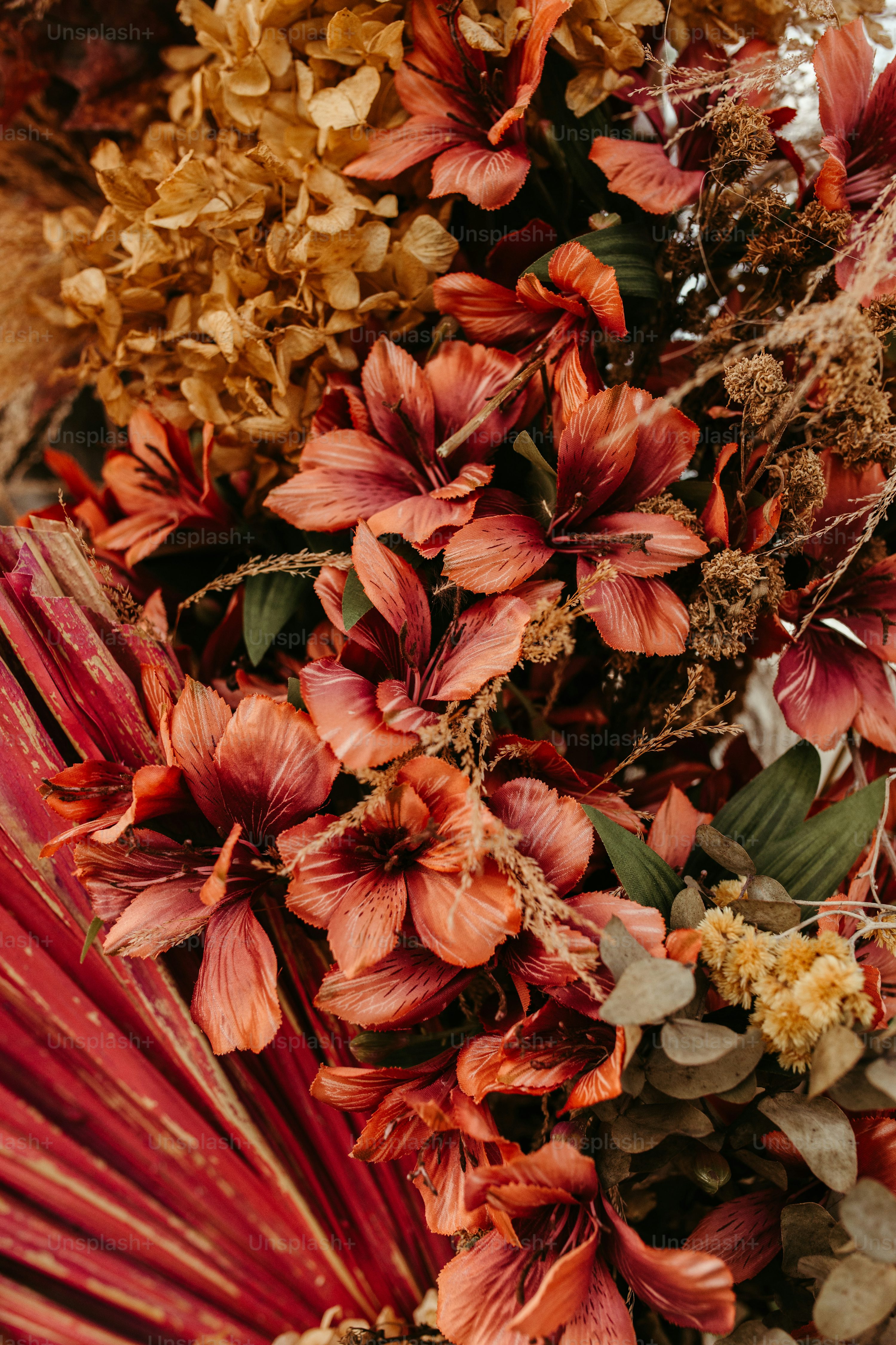 A bunch of flowers that are next to a red umbrella photo