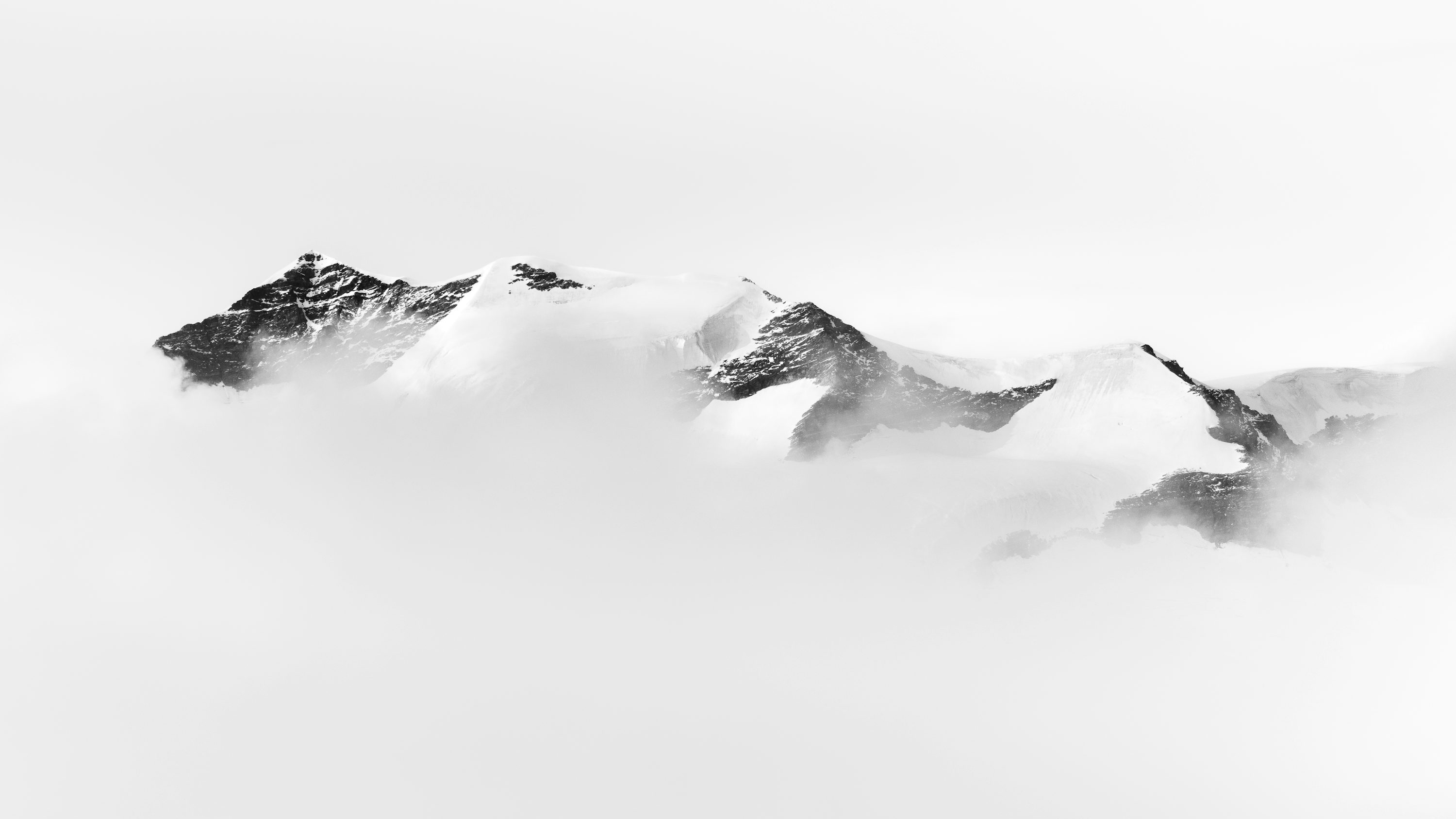 A black and white photo of snow covered mountains photo