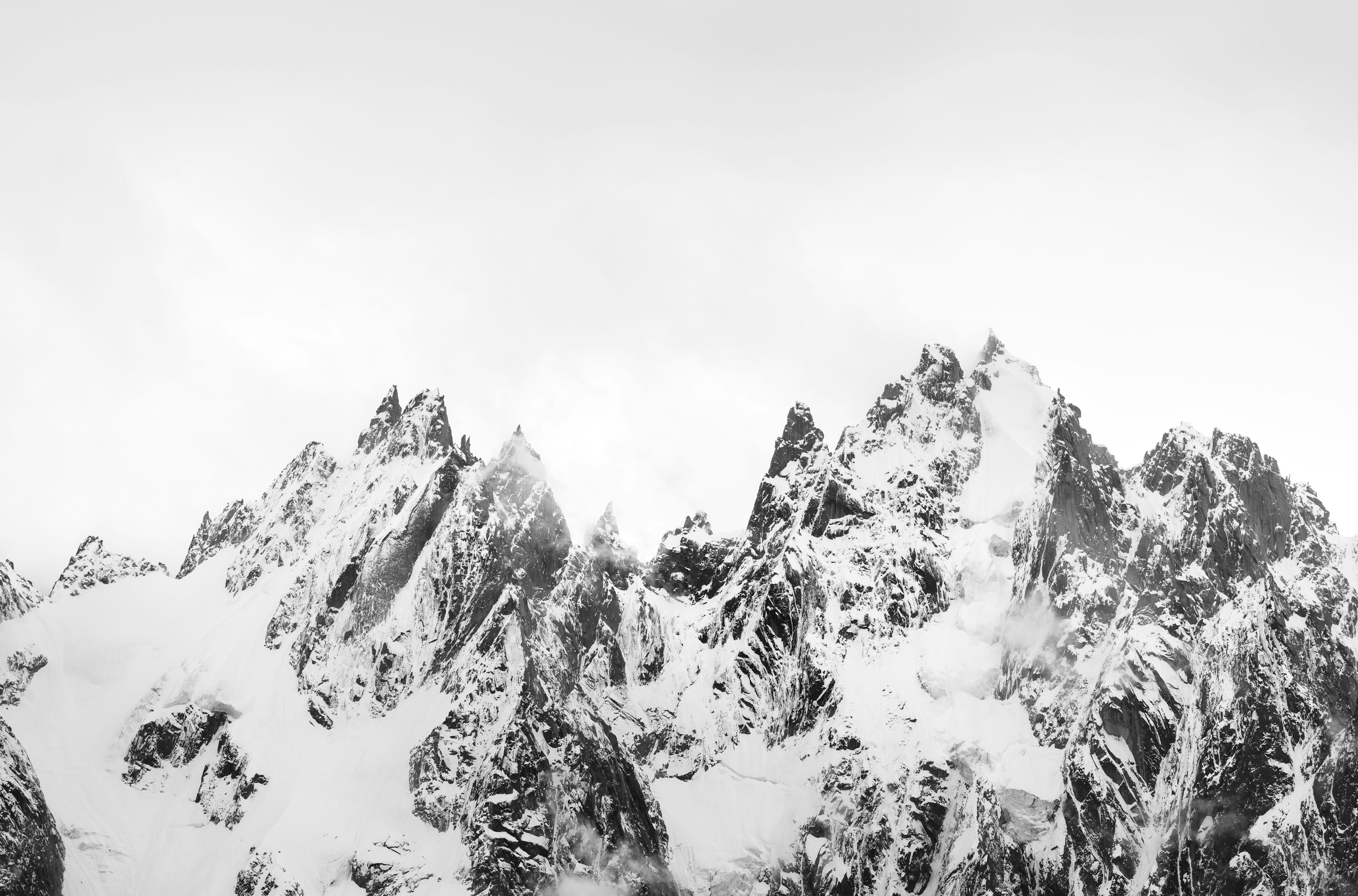 A black and white photo of snow covered mountains photo
