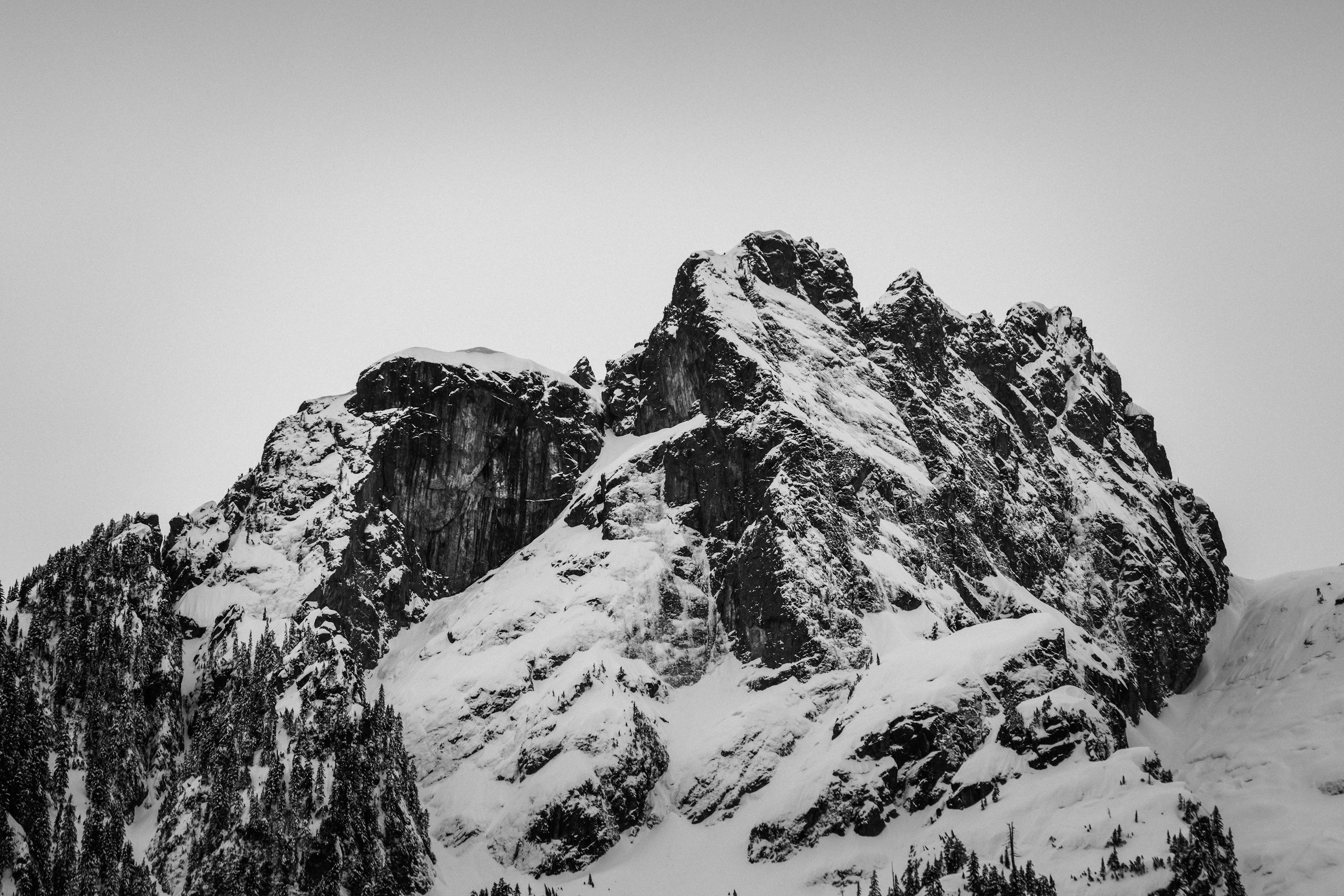 A black and white photo of snow covered mountains photo