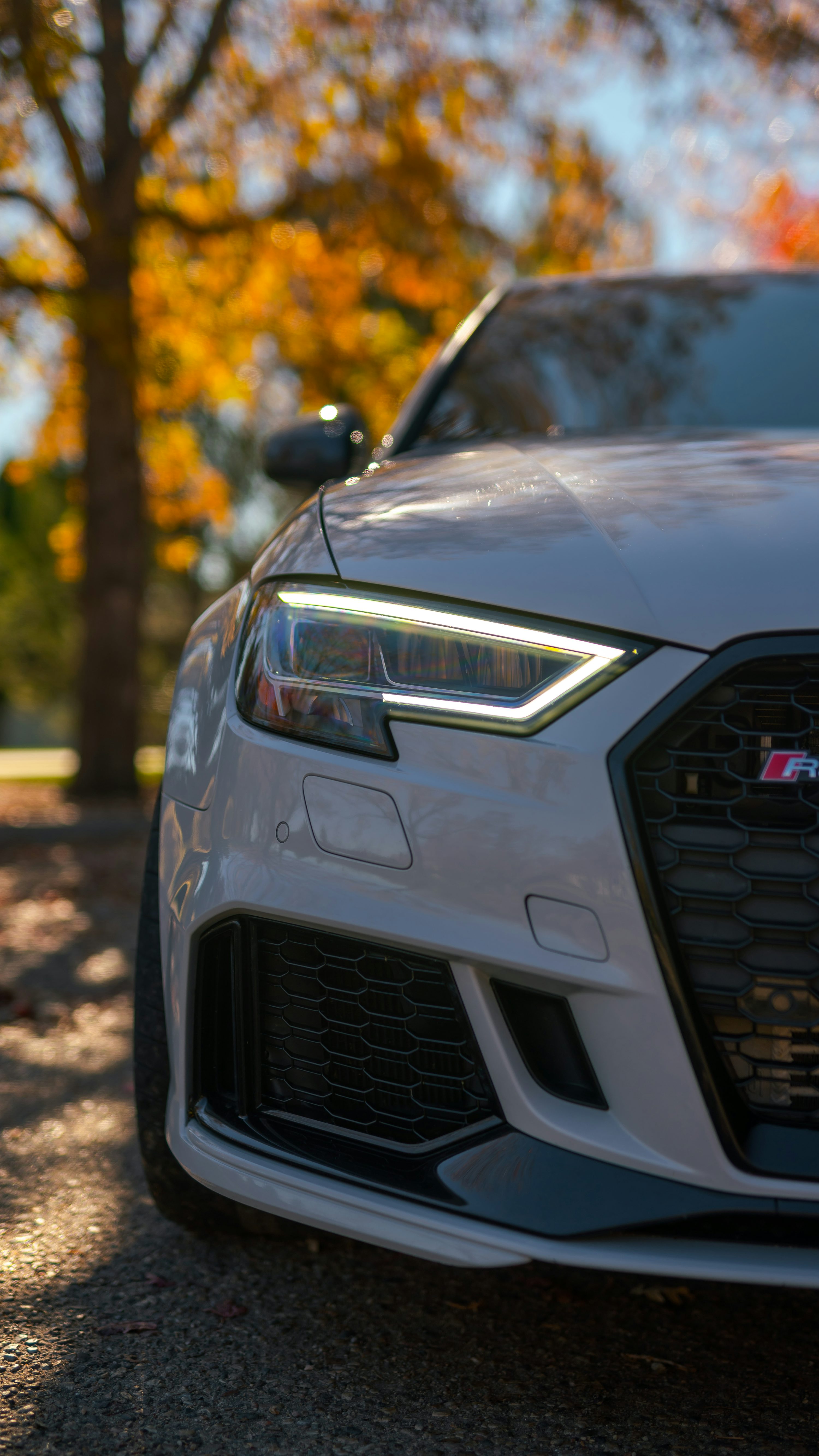 A close up of the front of a white car photo