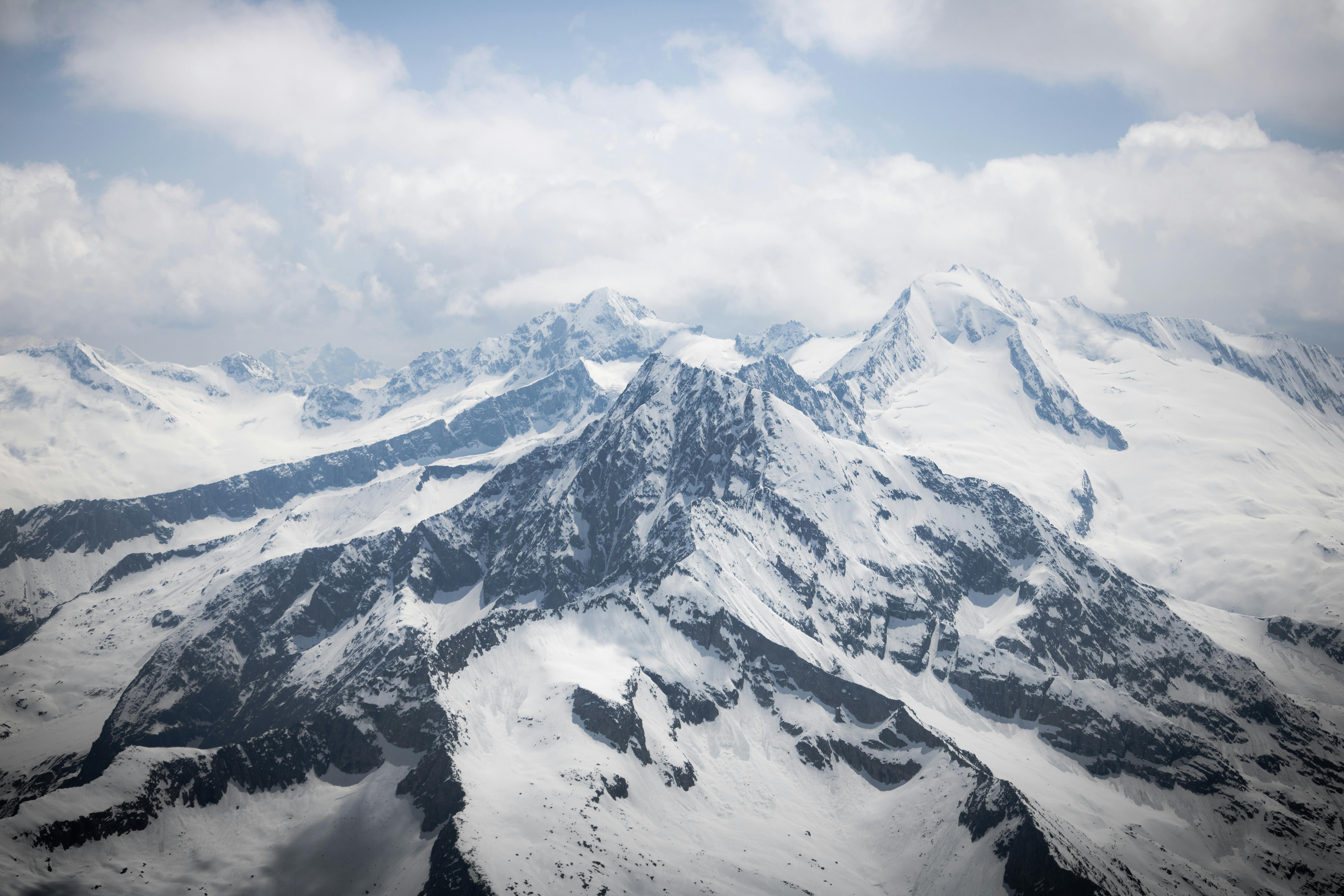 A view of a snowy mountain range from an airplane · Free